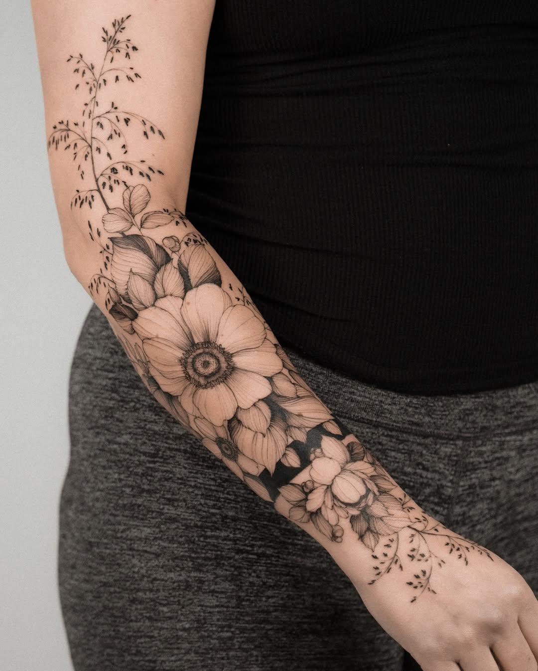 Floral sleeve with grass and flowers fine line tattoo on the forearm by Marek