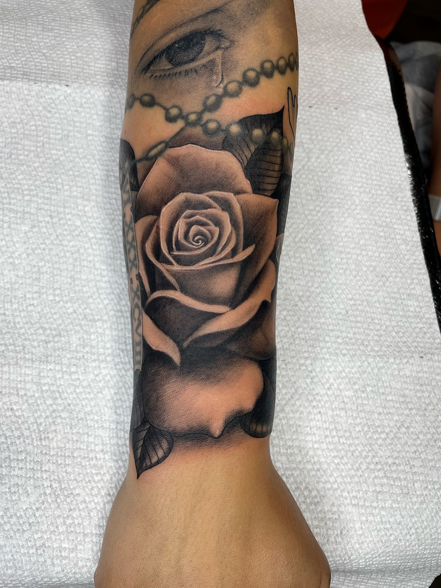 Rose realism tattoo on the forearm by Alex Ortiz