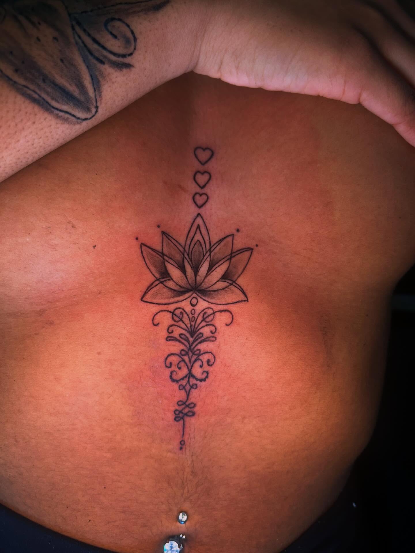Lotus flower geometric tattoo on the ribs by Detroit tattoo Artist
