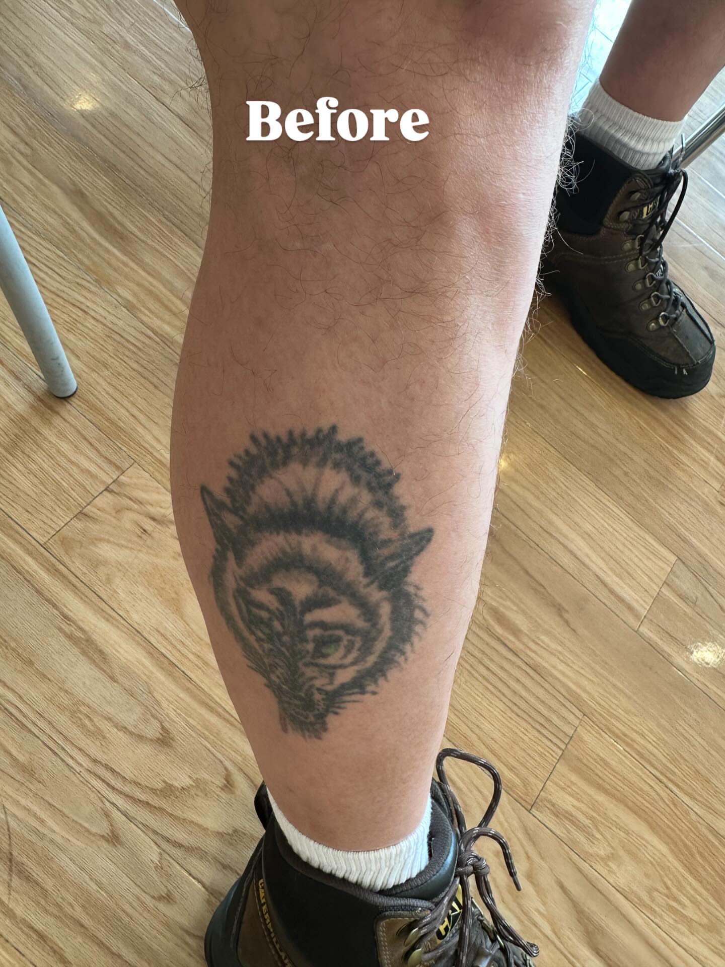 Wolf black and grey tattoo on the calf by Bobby Glennon