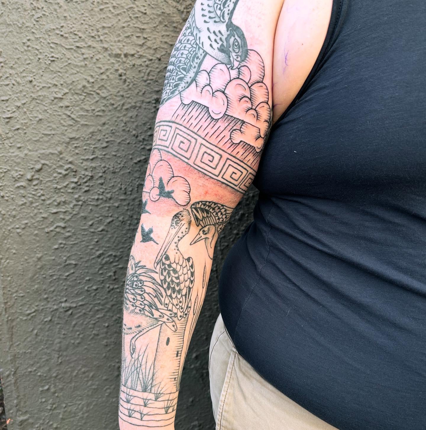 Birds and clouds black and grey tattoo on the forearm by Erica Finley