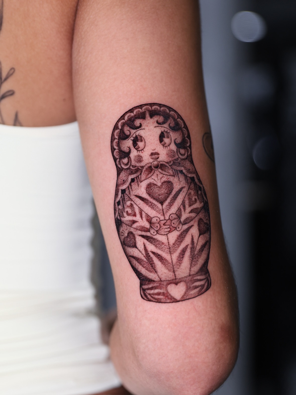 Matryoshka doll black and grey tattoo on the forearm by Hannah Burnside, Charlotte, North Carolina