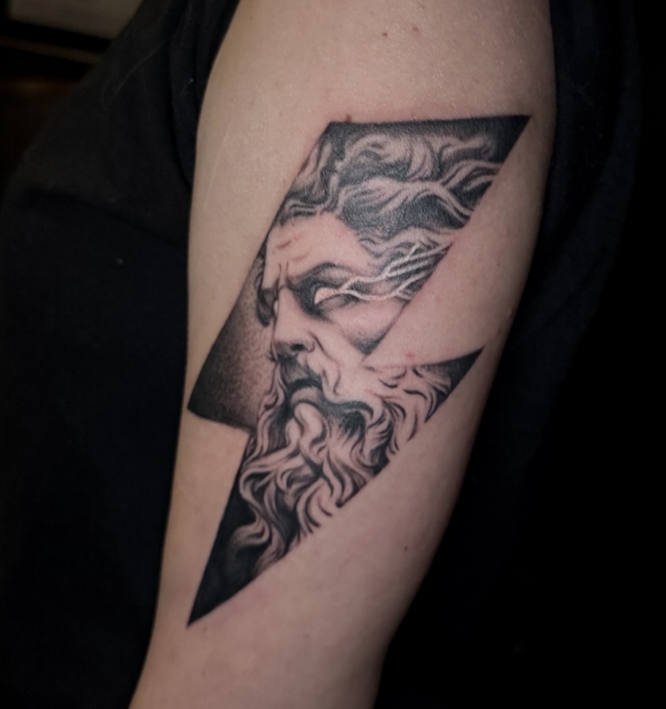Bearded man black and grey tattoo on the forearm by Hali Larkin