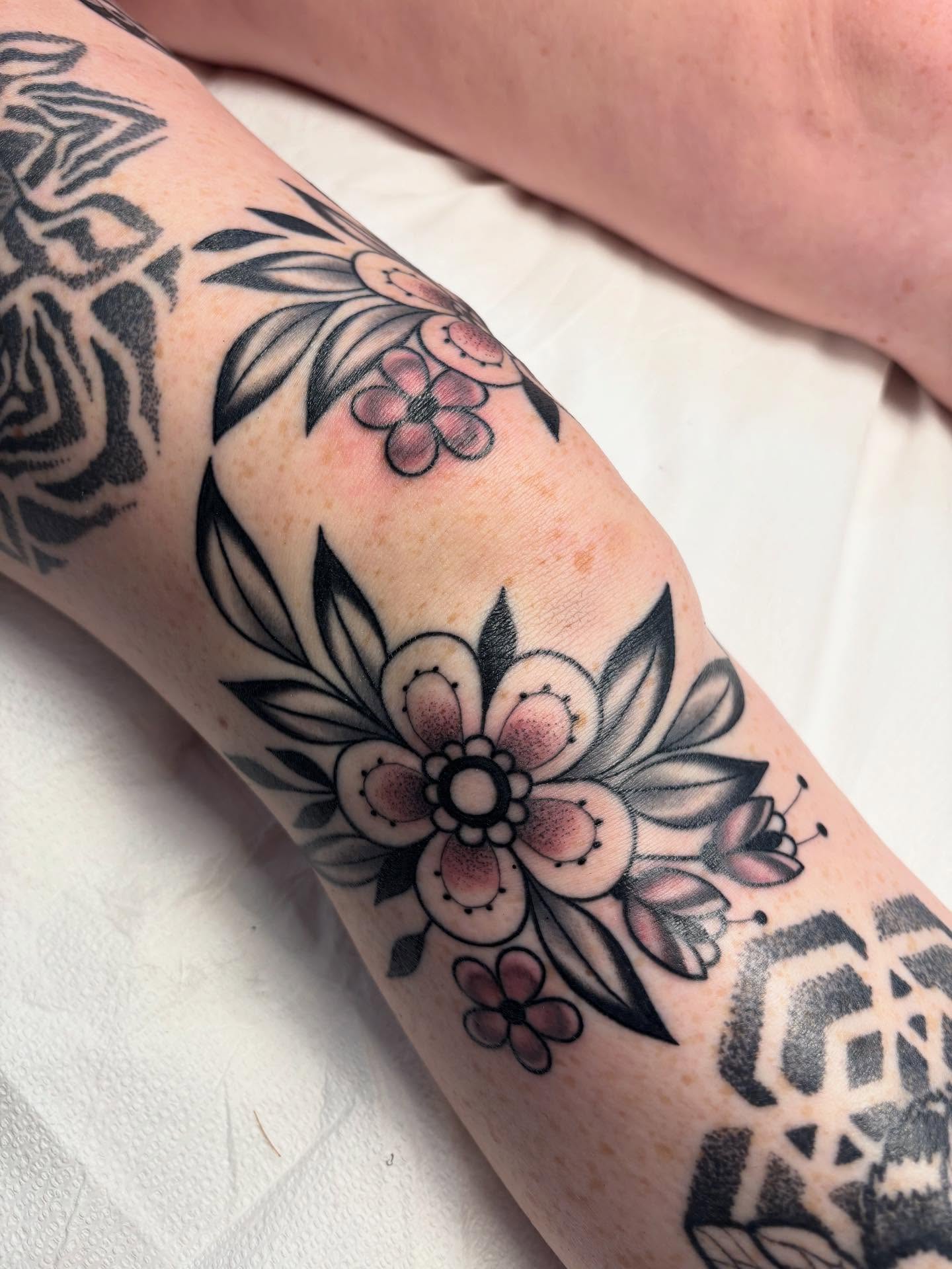 Floral arrangement American traditional tattoo on the forearm by Victoria Bacon