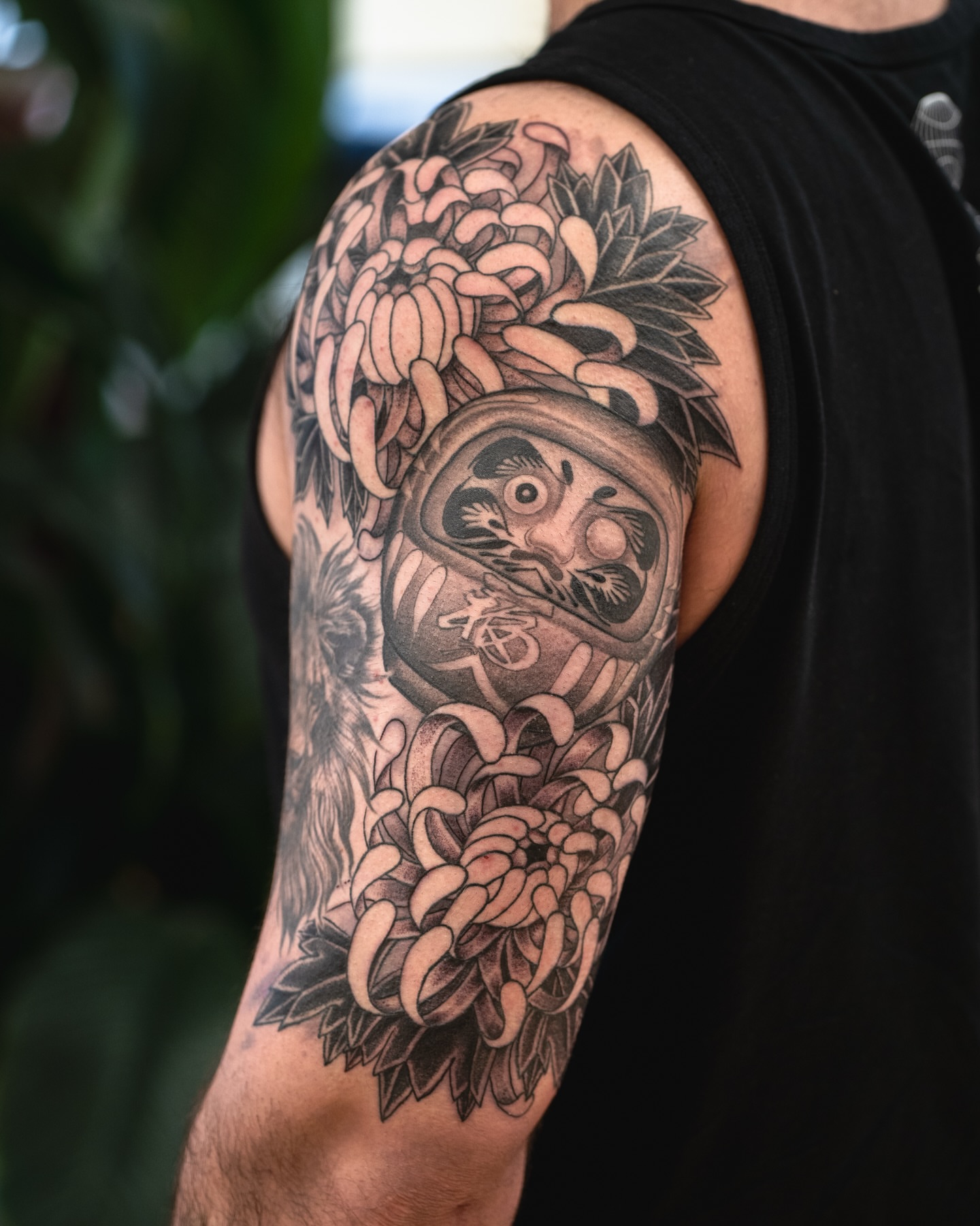 Japanese ghost mask with chrysanthemums japanese irezumi tattoo on the upper arm by James Fernella, San Francisco, California