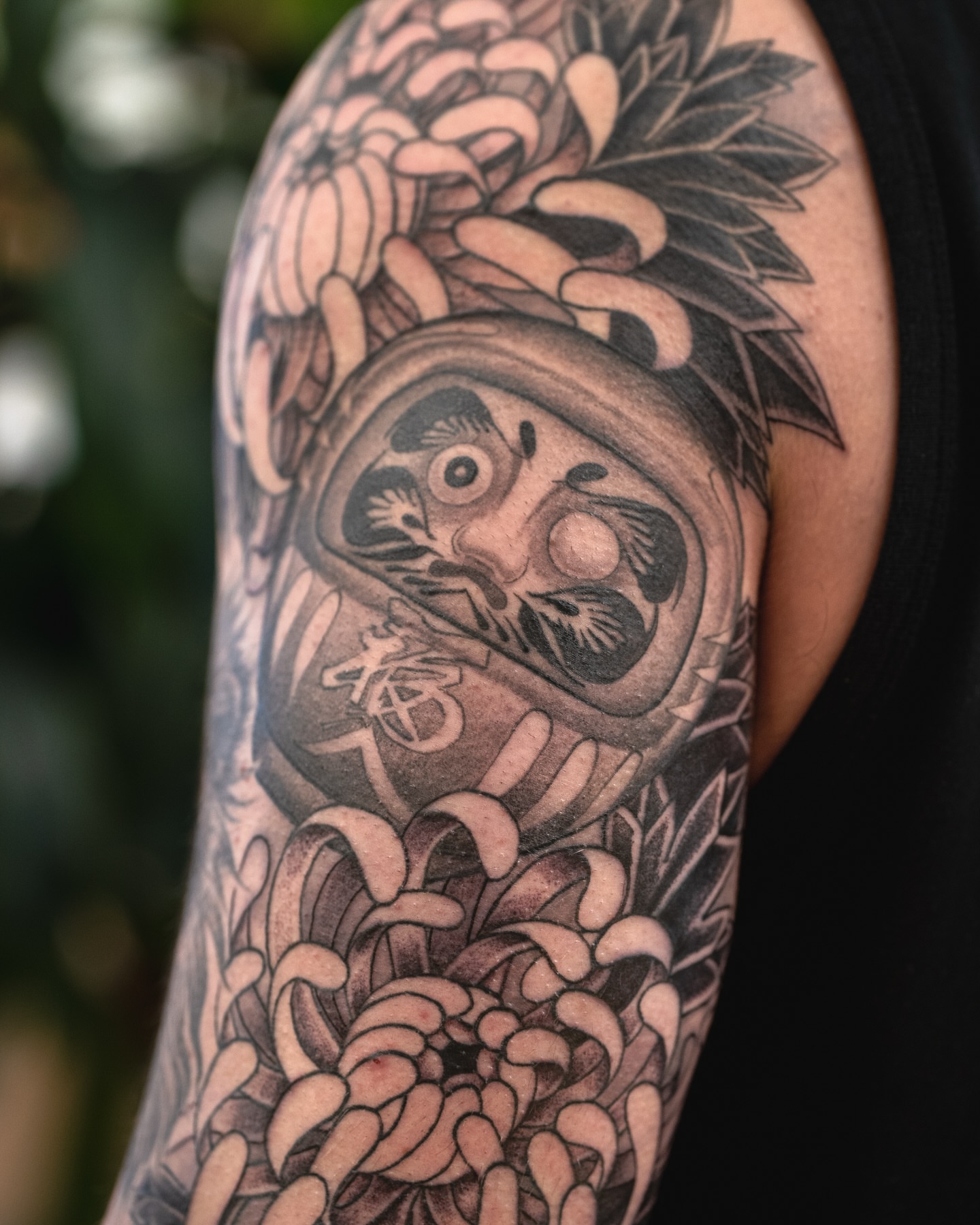 Mask with chrysanthemums japanese irezumi tattoo on the upper arm by James Fernella, San Francisco, California