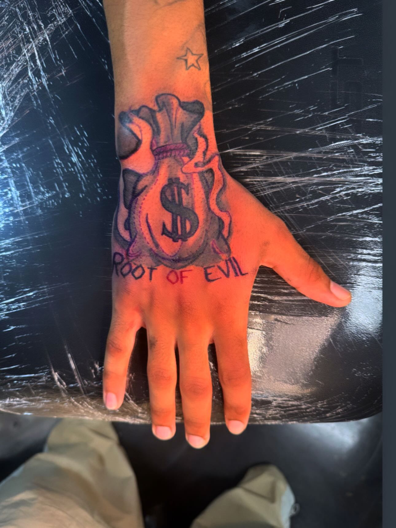 Money bag American traditional tattoo on the hand by Anthony Washington, Atlanta, Georgia