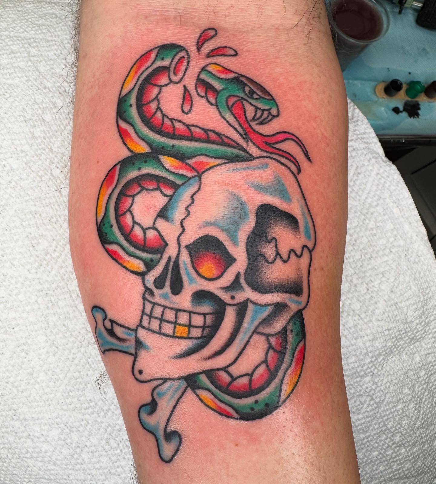 Skull and snake American traditional tattoo on the forearm by Brandon Heredia, Vacaville, California