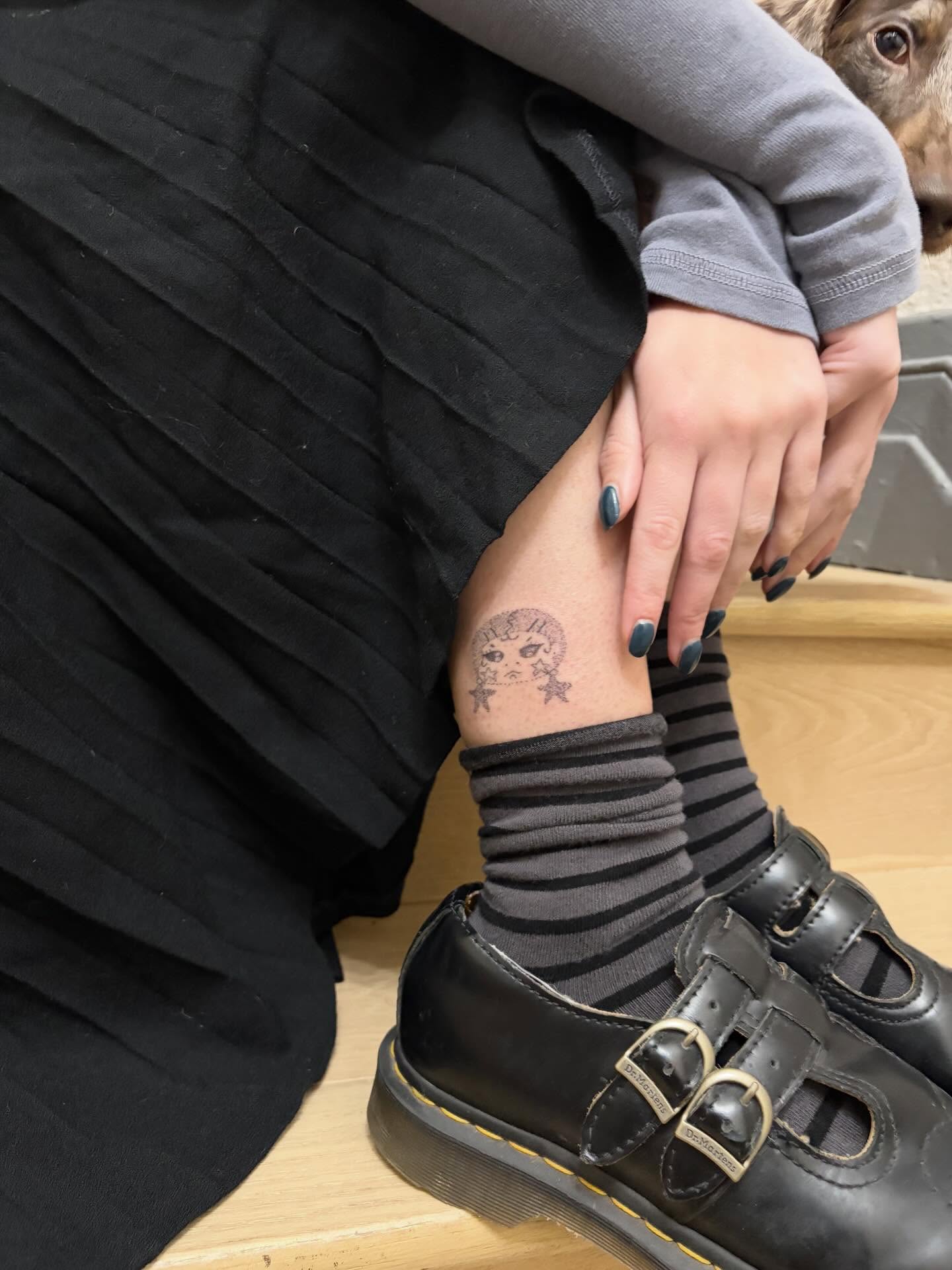 Face with crown black and grey tattoo on the calf by kari