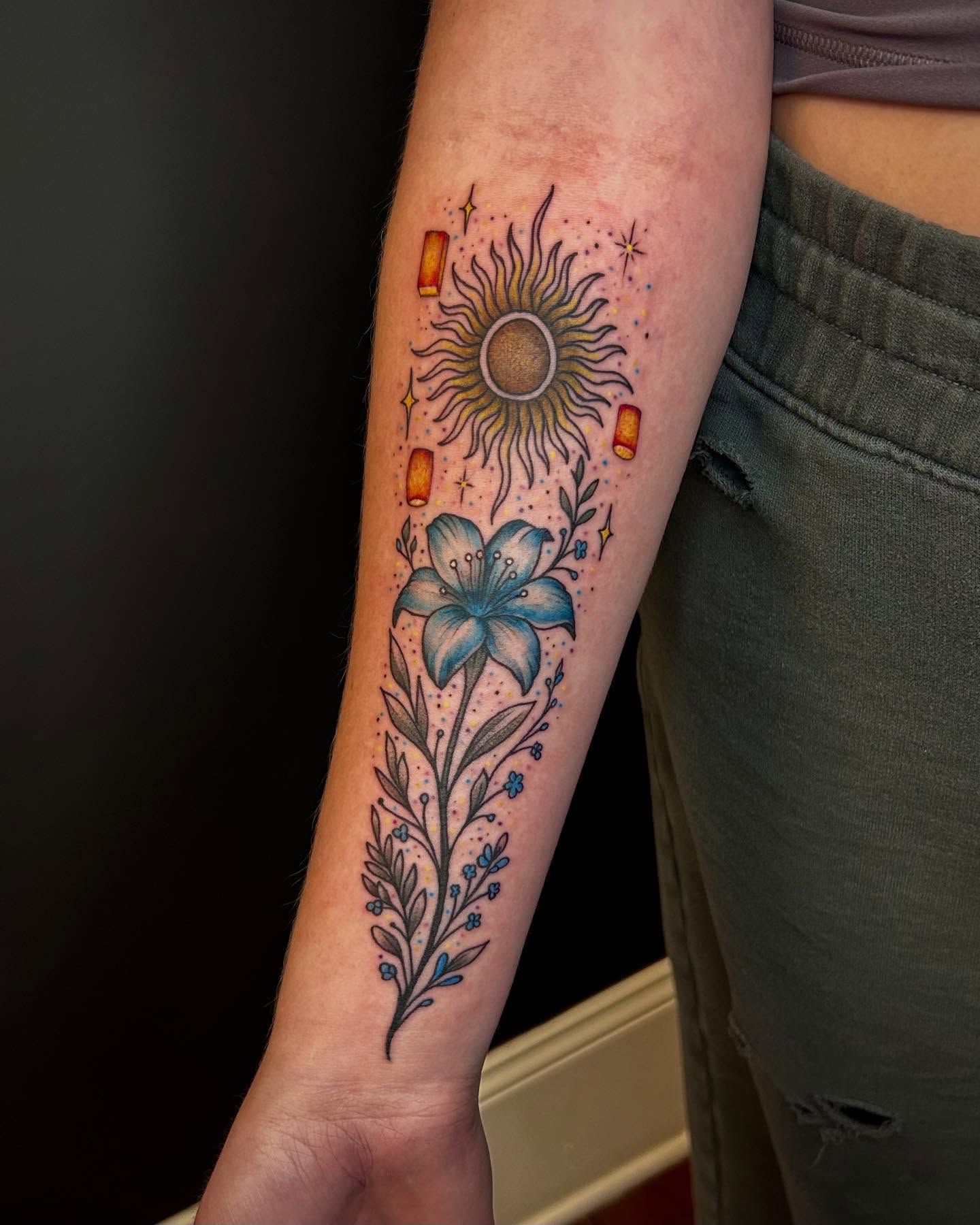 Sun and lily dotwork tattoo on the forearm by Jon Byrd
