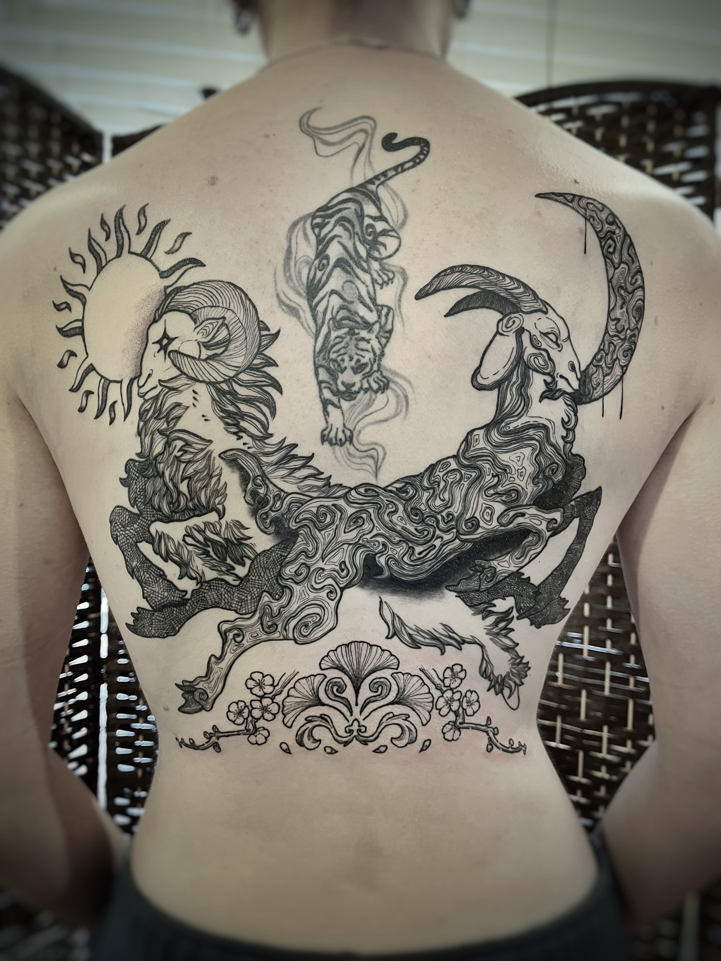 Mythical creatures and sun surrealism tattoo on the back by Risa Cincinnati Tattoo Artist