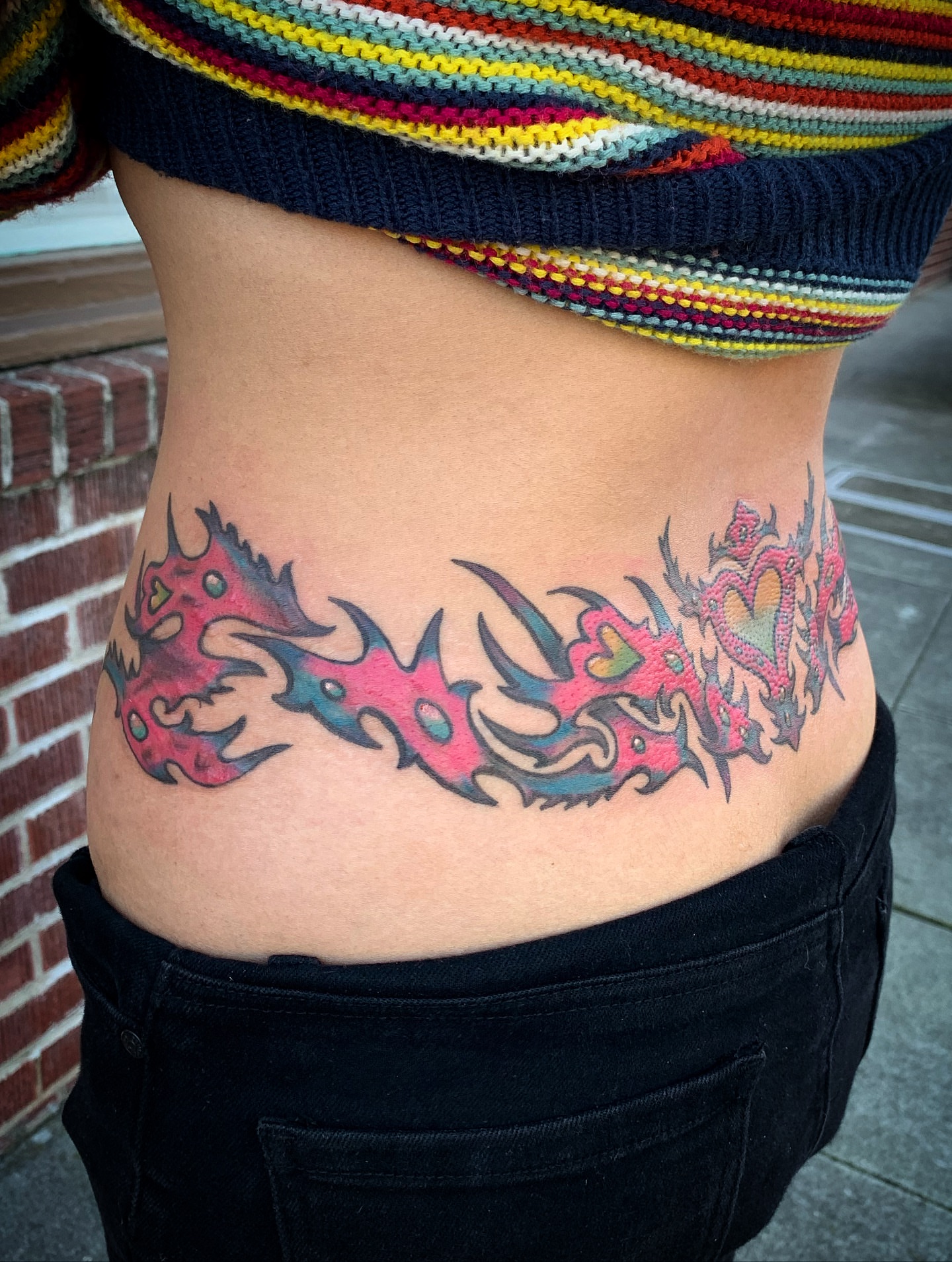 Flame design tribal tattoo on the torso by Laura