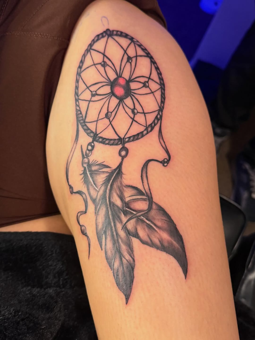 Dreamcatcher with feathers fine line tattoo on the thigh by Sonia vidal