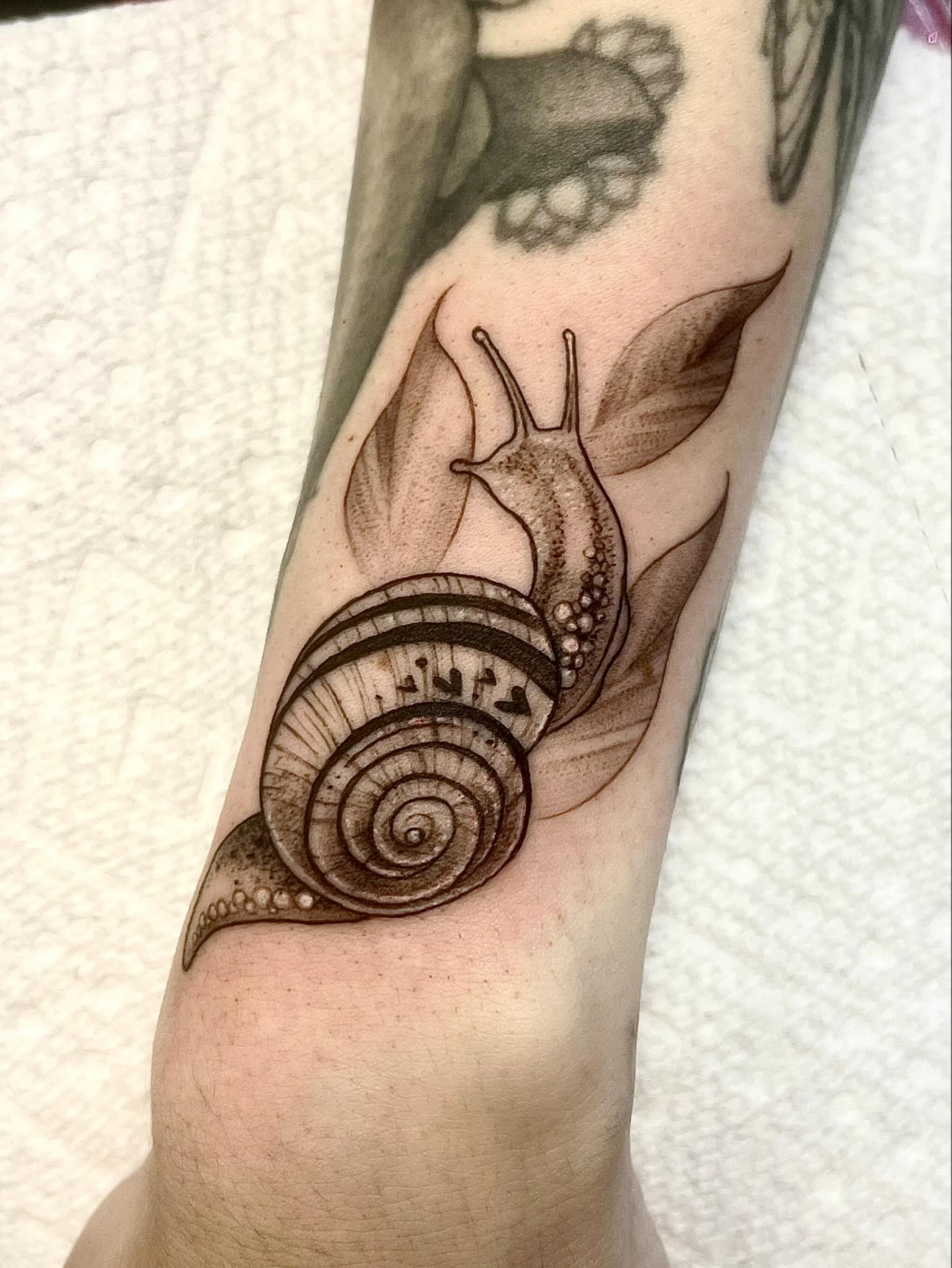 Snail black and grey tattoo on the forearm by Joi Bailey, Denton, Texas