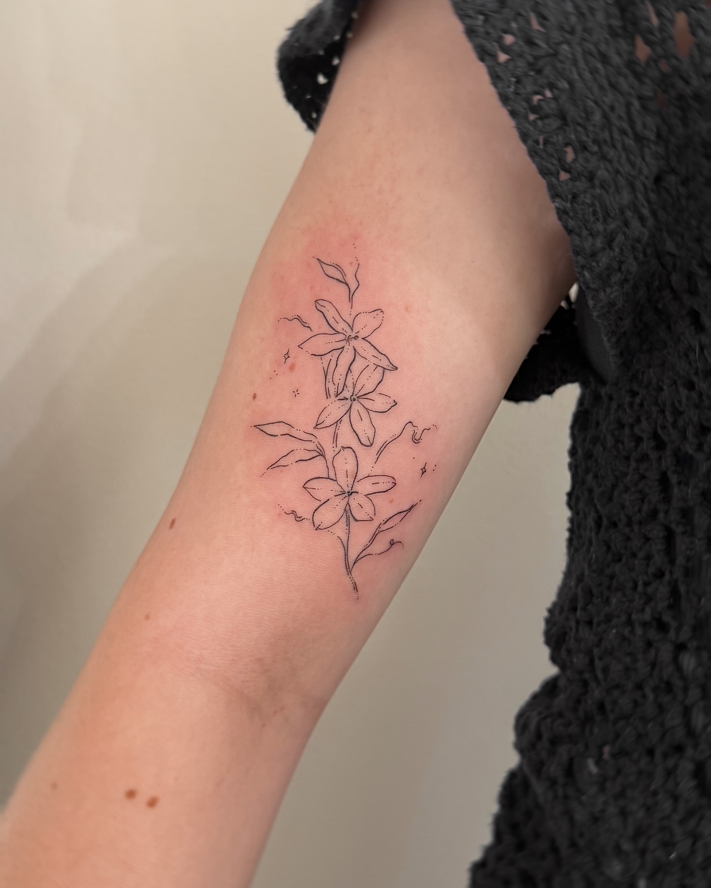 Lilies fine line tattoo on the forearm by Inky Apricot, Austin, Texas