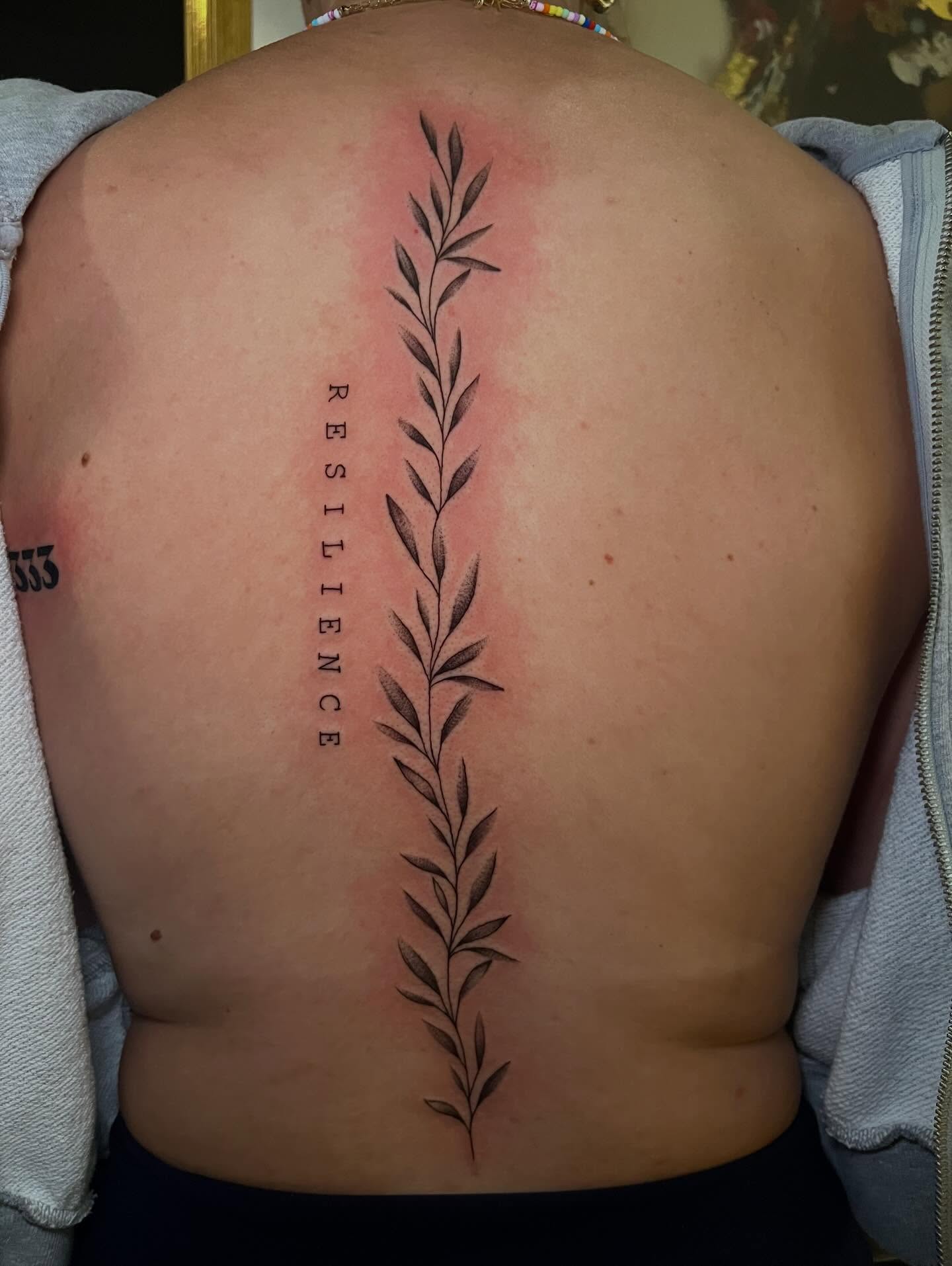 Leafy vine dotwork tattoo on the back by Baung Ben