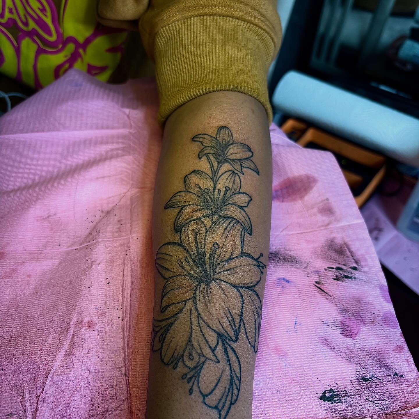 Lilies black and grey tattoo on the forearm by Barbinks Studio🎀