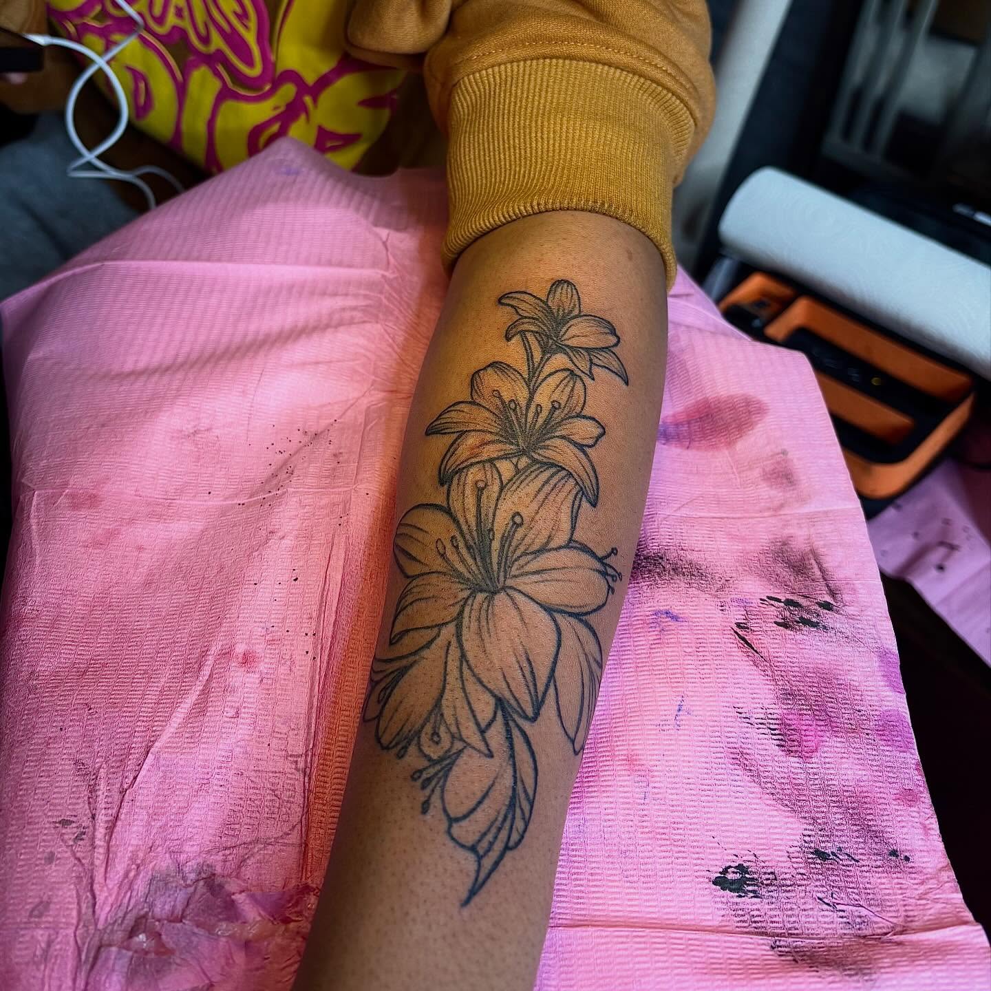 Lilies black and grey tattoo on the forearm by Barbinks Studio🎀