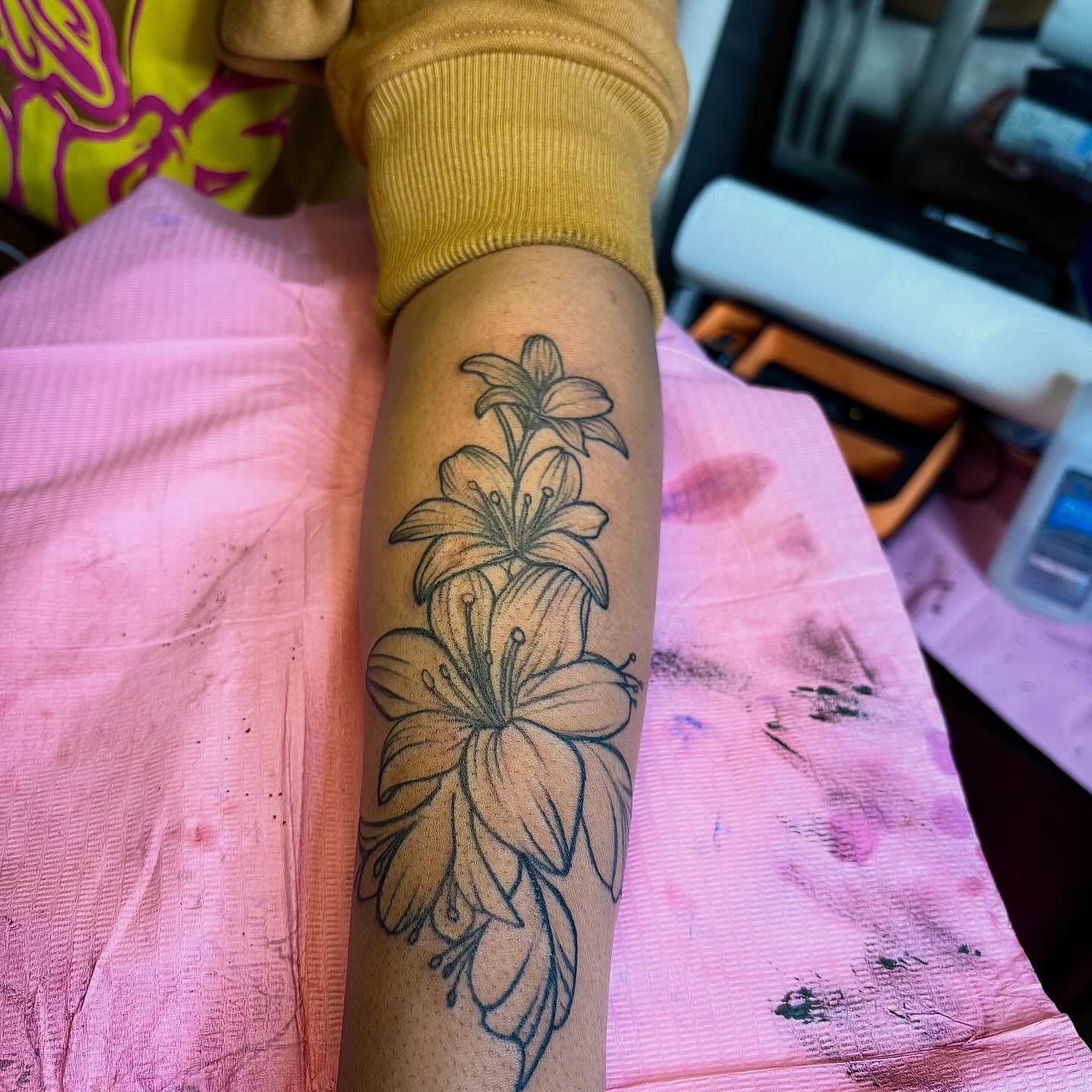 Lilies black and grey tattoo on the forearm by Barbinks Studio🎀