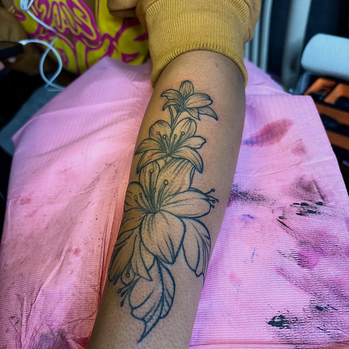 Lilies black and grey tattoo on the forearm by Barbinks Studio🎀