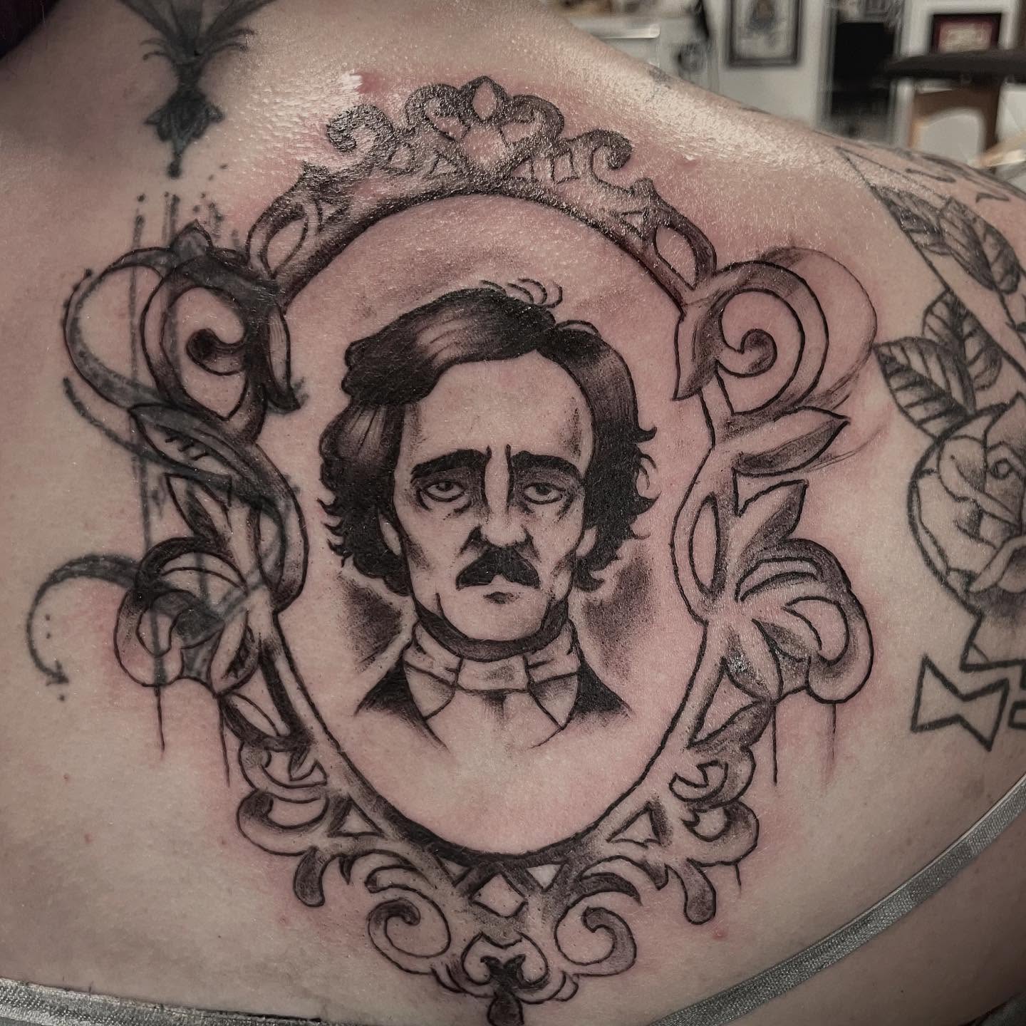 Edgar Allan Poe black and grey tattoo on the back by Logan Casimir