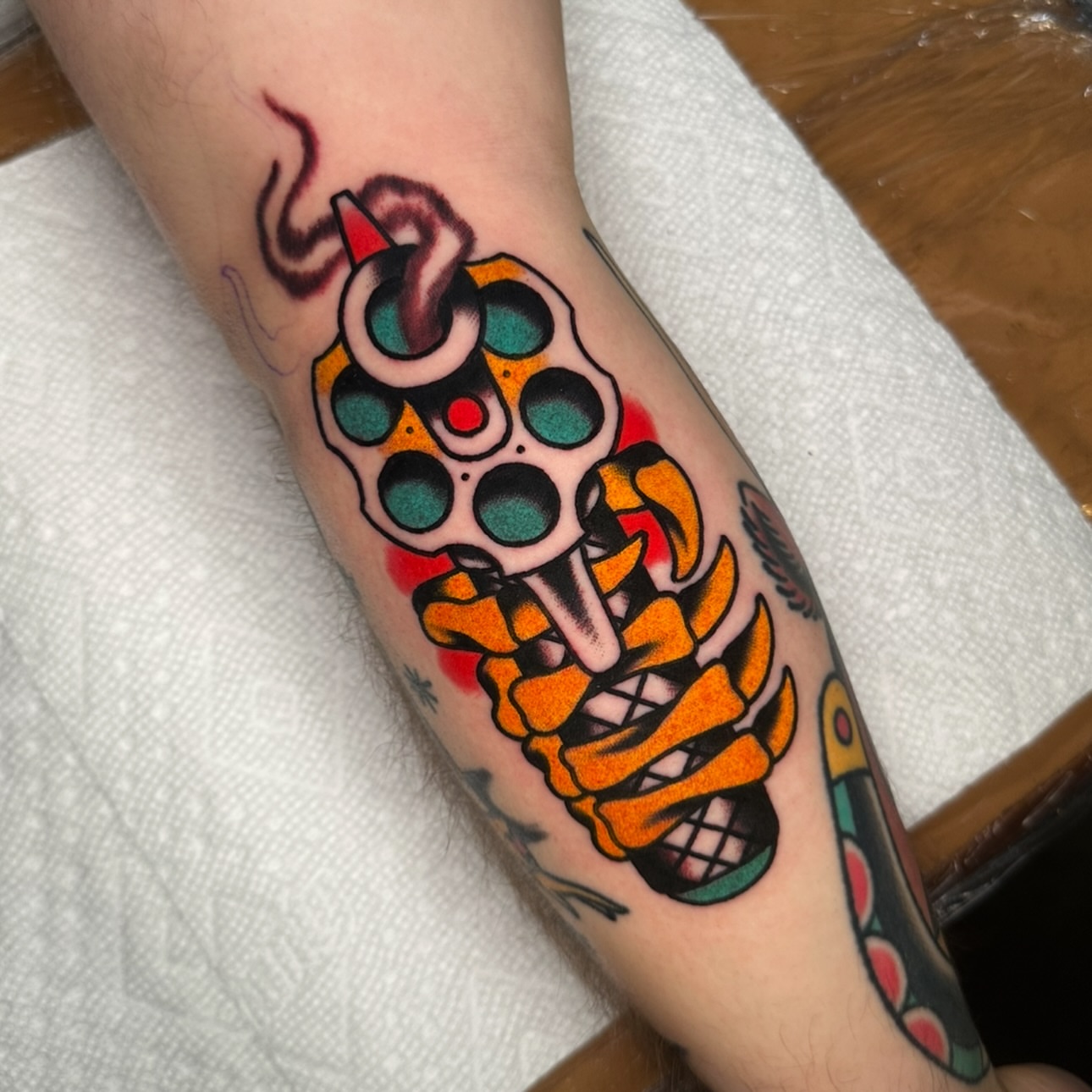 Gun and skeleton American traditional tattoo on the forearm by Schyler Ames, Canal Fulton, Ohio