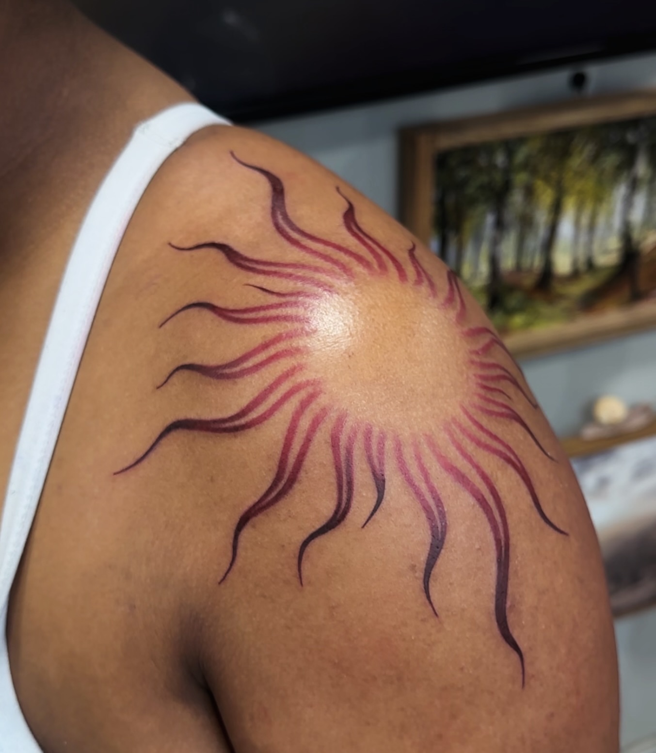 Sunburst dotwork tattoo on the shoulder by Arielle Deatherage
