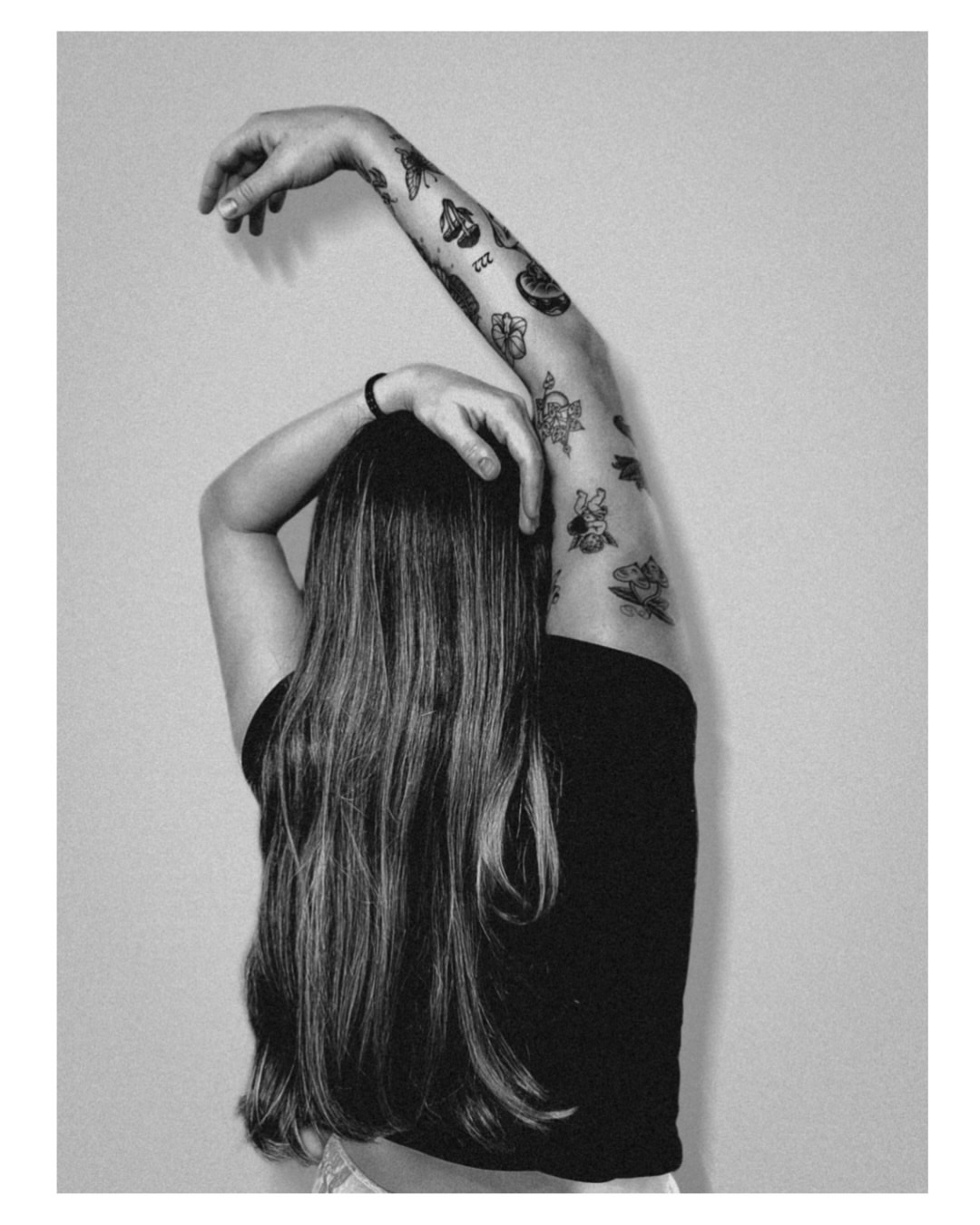 Floral design black and grey tattoo on the upper arm by Jordyn Tinney