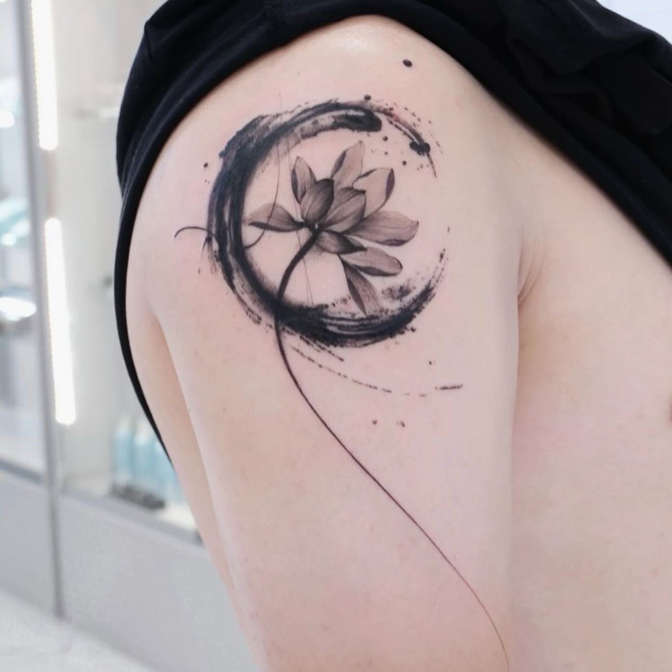 Lotus flower black and grey tattoo on the thigh by MJ tattooist