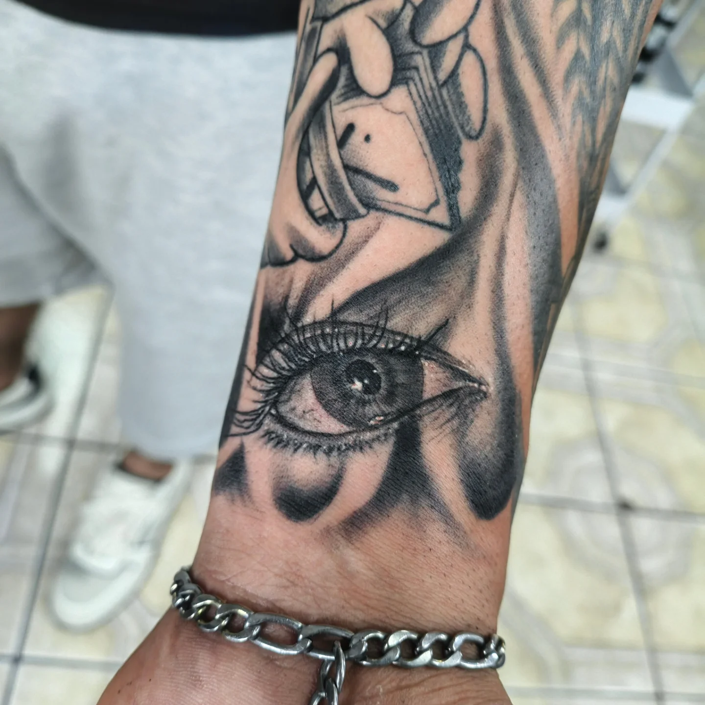 Eye and hand realism tattoo on the forearm by Alexander Tattooink