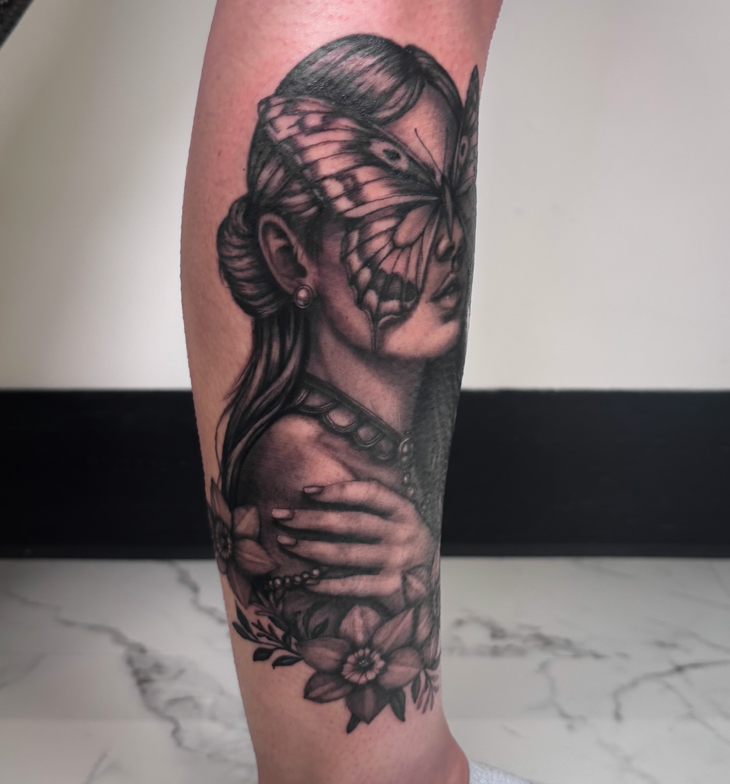 Woman with butterfly realism tattoo on the forearm by utah tattoo artist