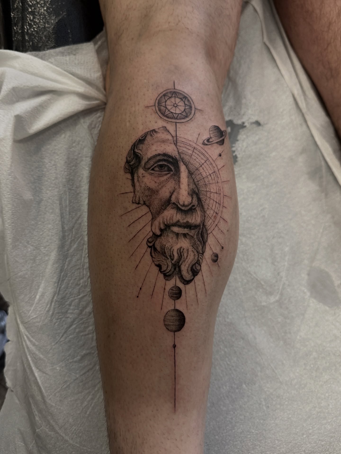 Astronomical figure dotwork tattoo on the forearm by Matt Kearney