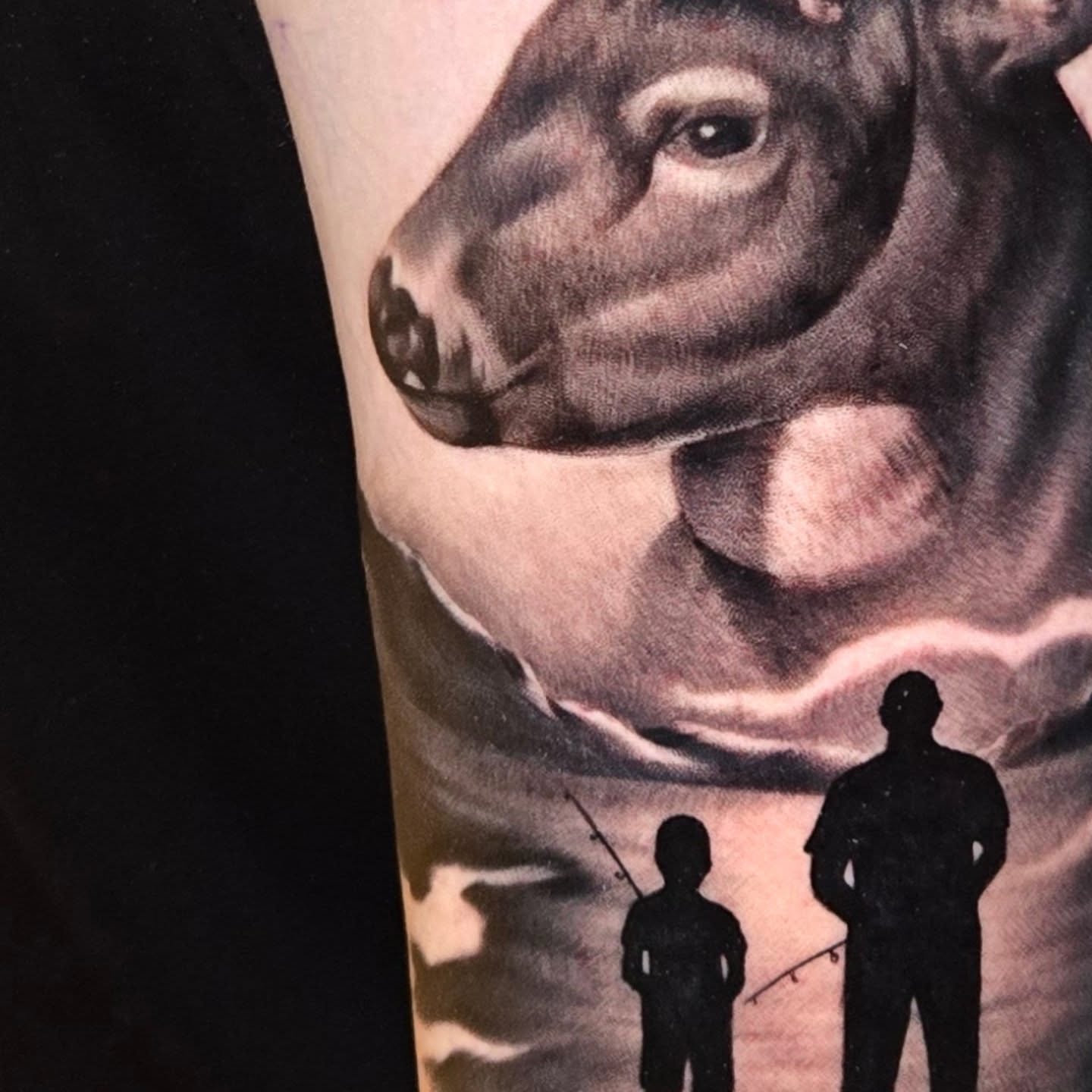 Cow and fishing scene realism tattoo on the forearm by Jeff Stager