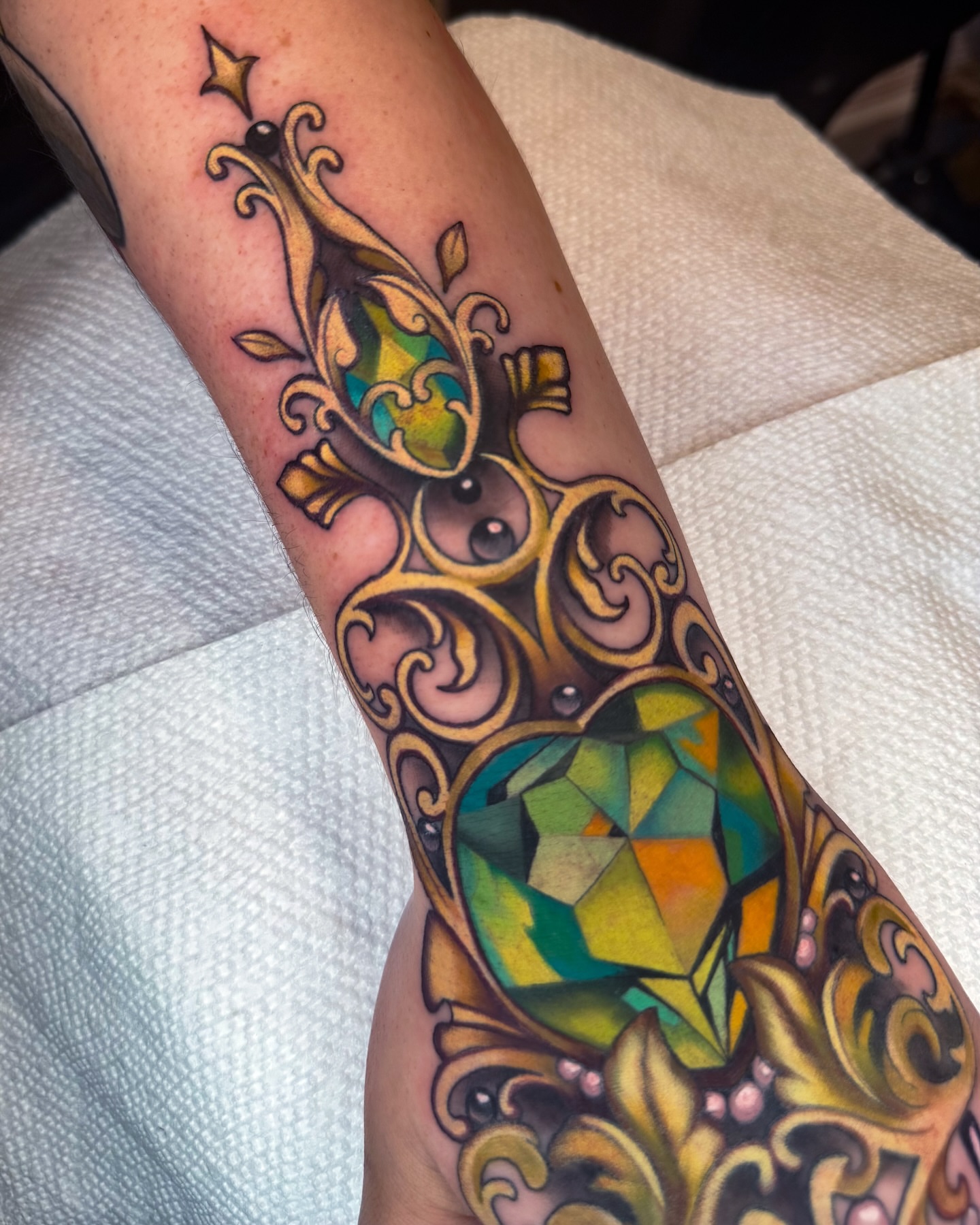 Gemstone and floral ornament geometric tattoo on the forearm by 𝔐𝔞𝔯𝔰 ✨