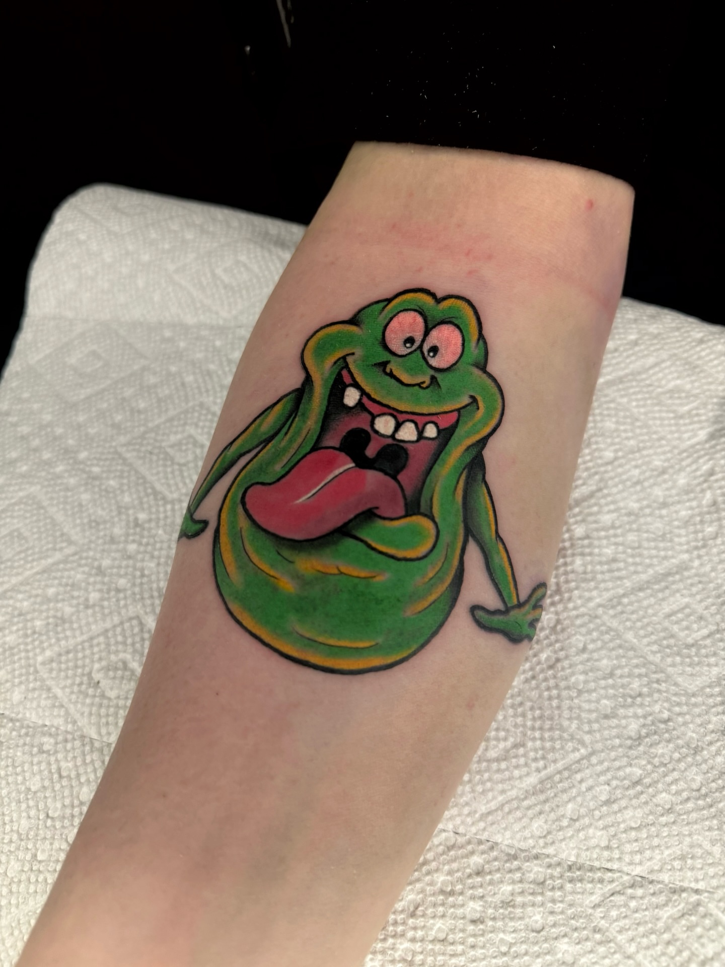 Slimer ghostbusters new school tattoo on the forearm by Brett Brown