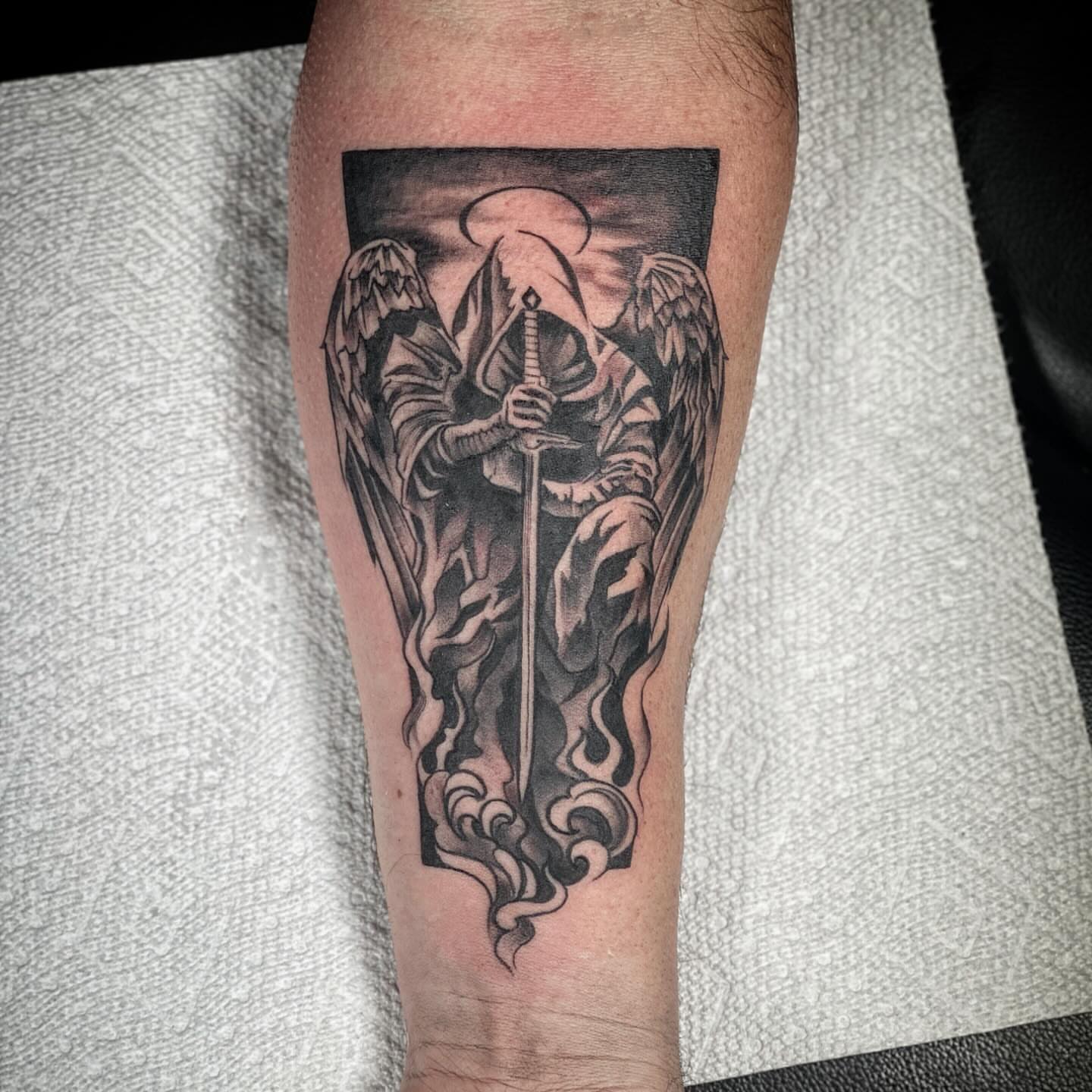 Grim reaper black and grey tattoo on the forearm by Chris Klee