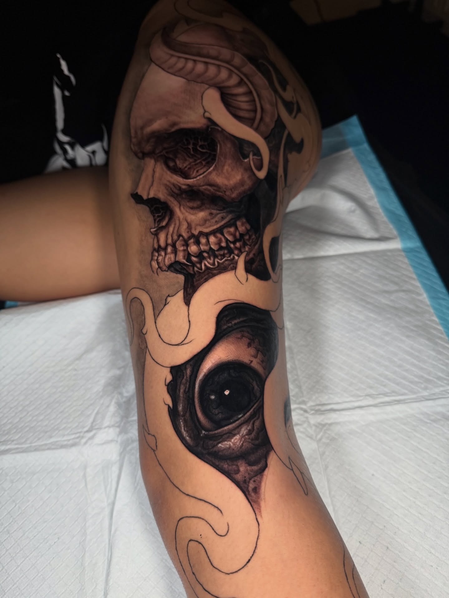 Eye and skull realism tattoo on the forearm by Isaac