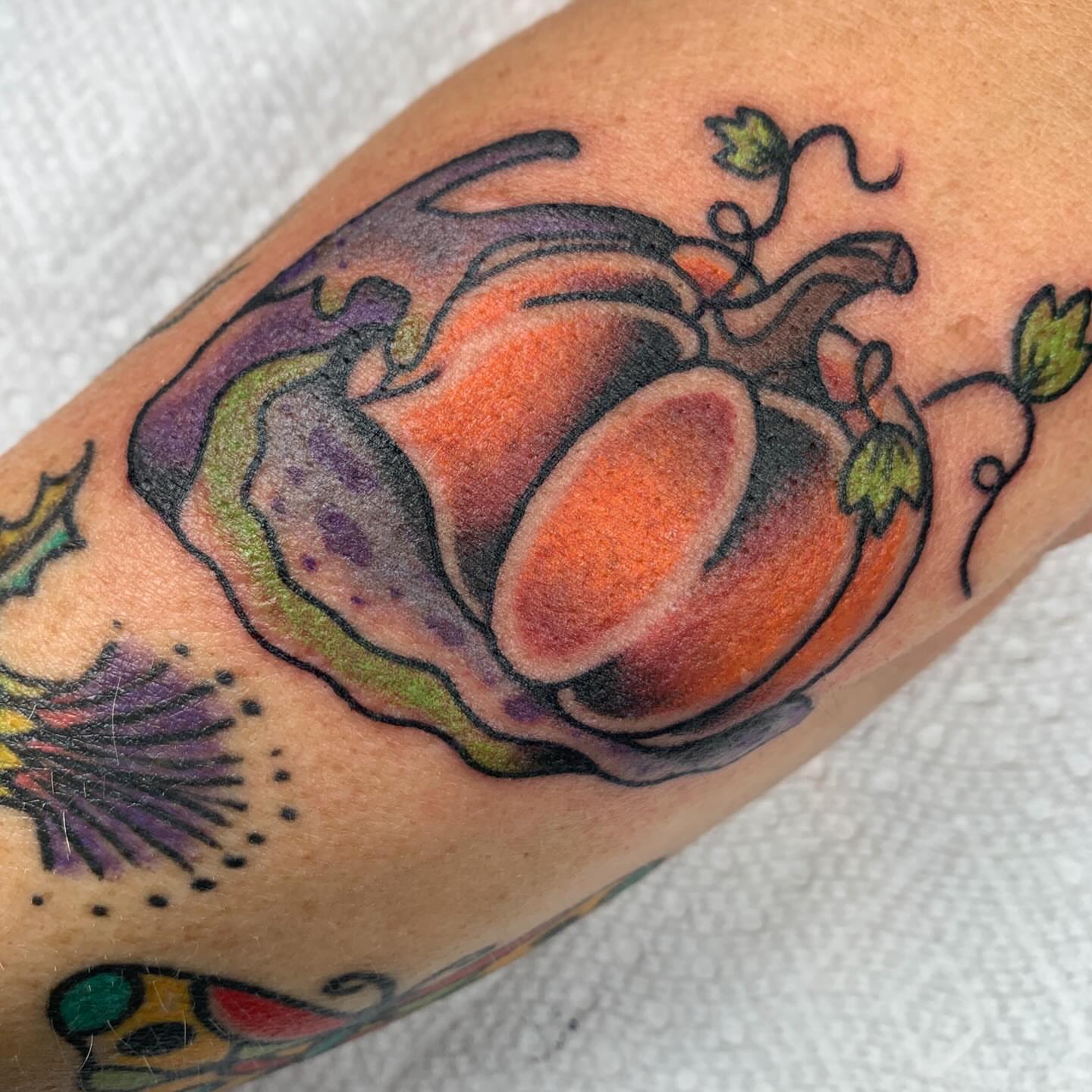 Pumpkin American traditional tattoo on the forearm by April Morris ⚔️ Tattoo Goblin