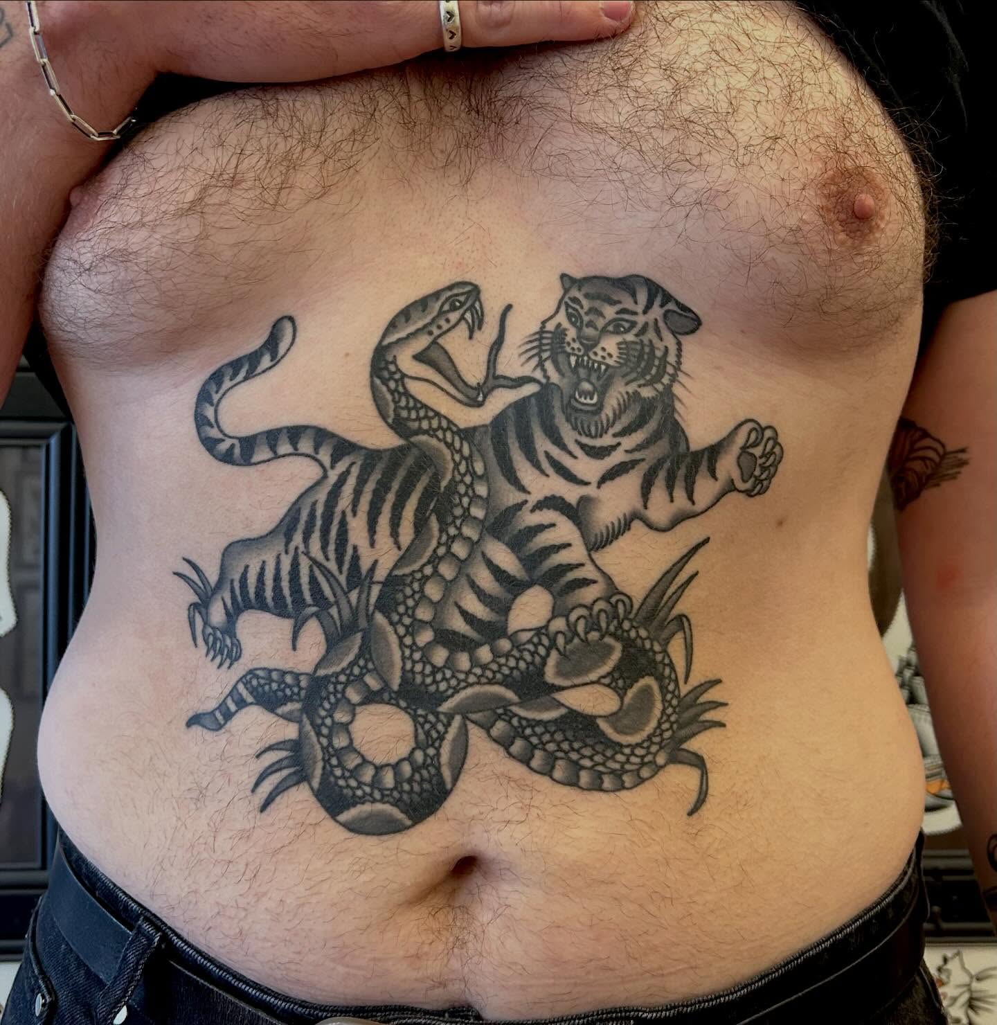 Tiger and snake black and grey tattoo on the ribs by Christian Lasyone