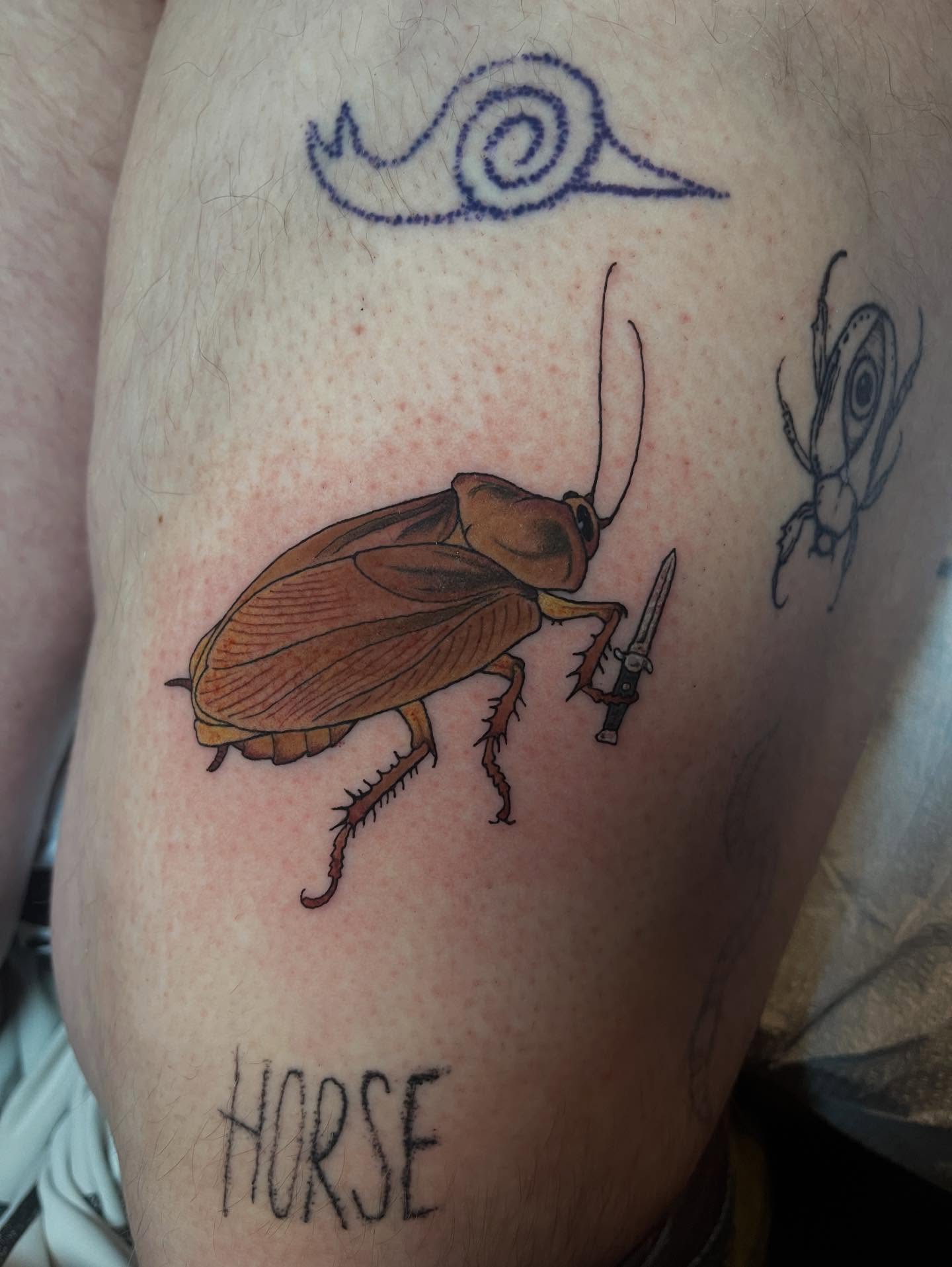Cockroach with knife realism tattoo on the thigh by Joe Moreira