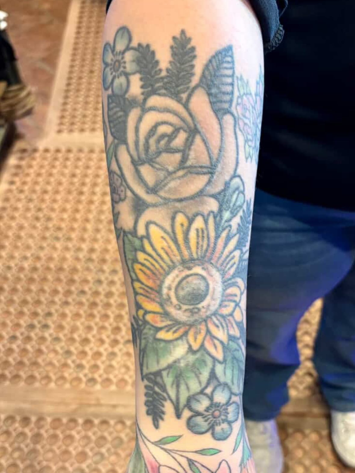Sunflower and rose American traditional tattoo on the forearm by Paris Romano