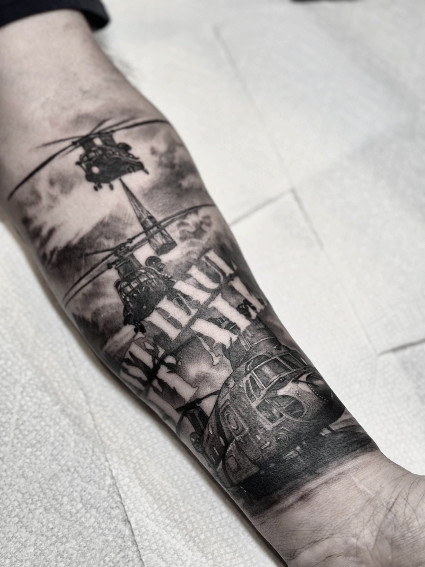 Helicopters realism tattoo on the forearm by Nick Fierro