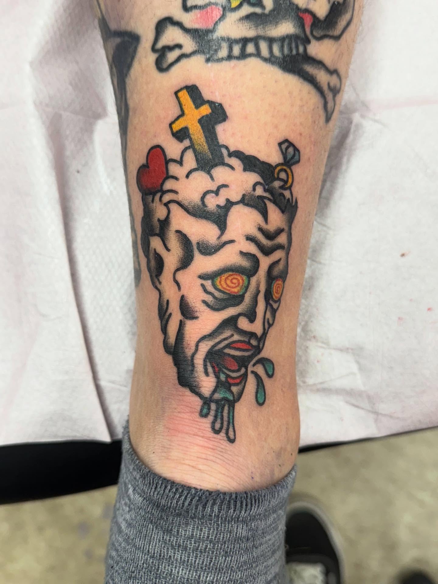 Demon face American traditional tattoo on the forearm by Jesse Coldiron