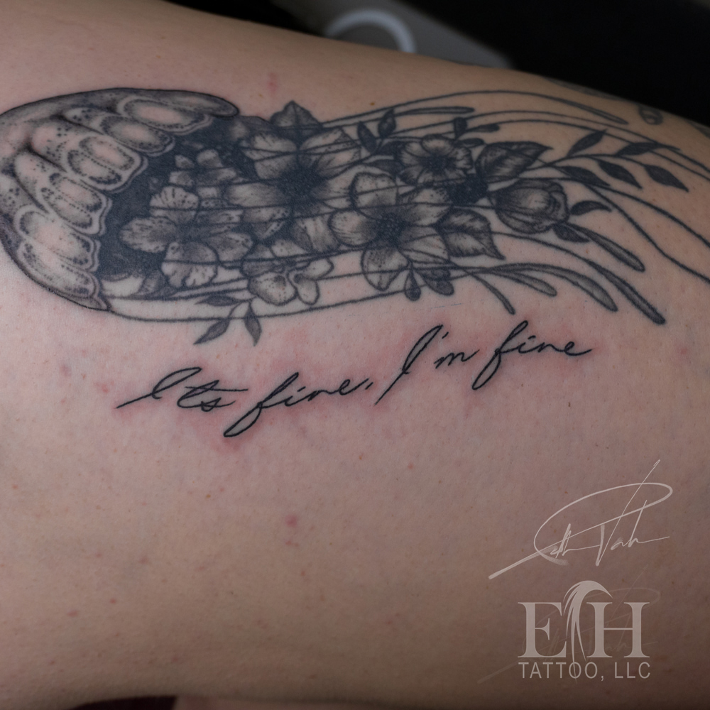 It's fine, I'm fine black and grey tattoo on the shoulder by Donald Voelker