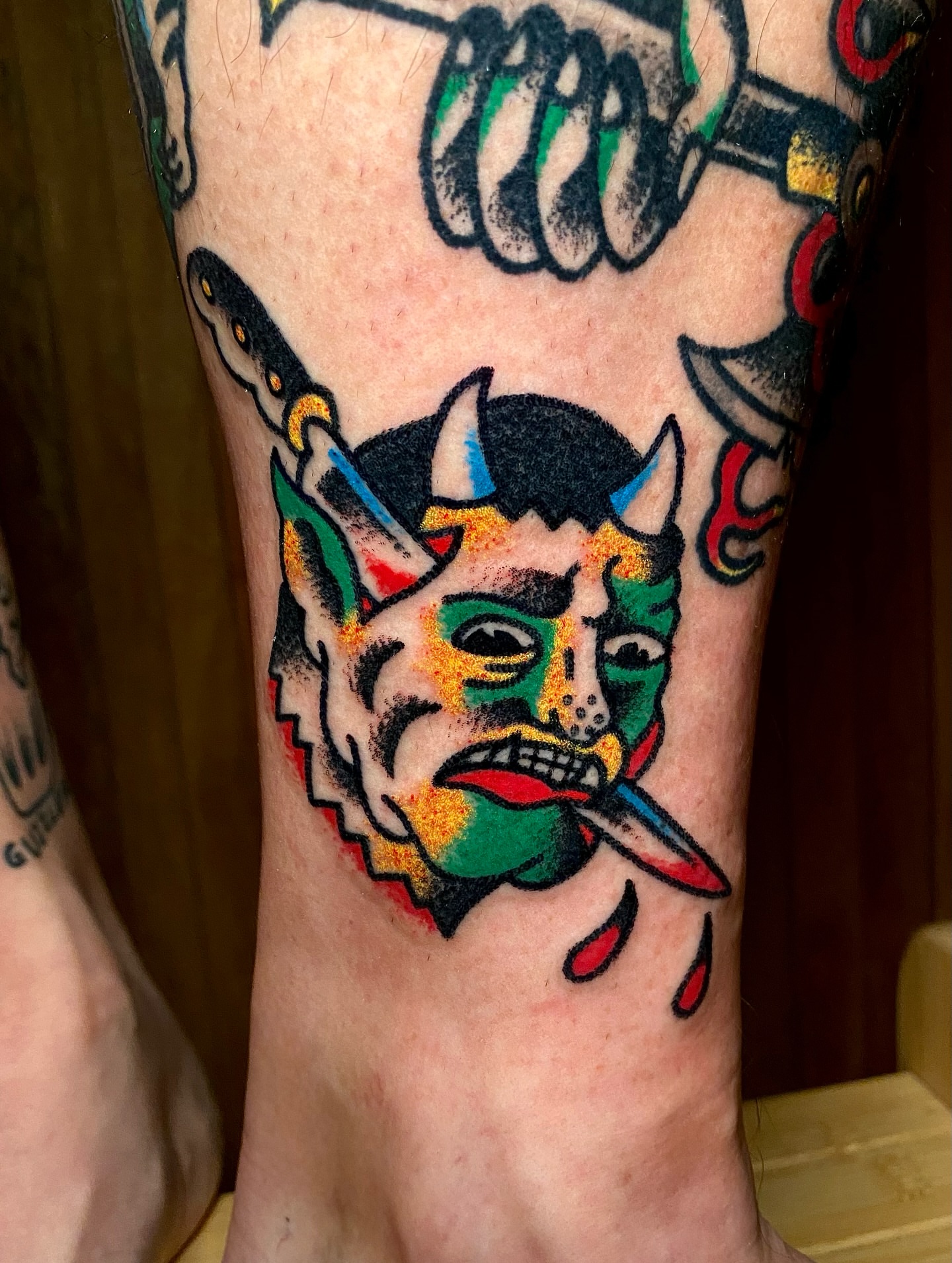 Demon head American traditional tattoo on the forearm by Daniel Diego