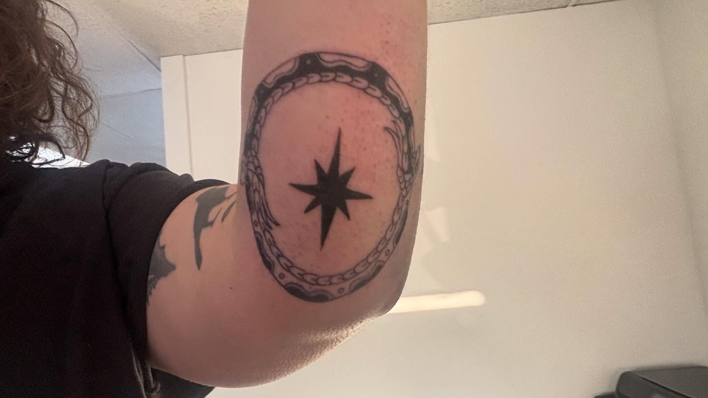 Star within chain geometric tattoo on the forearm by Mickey