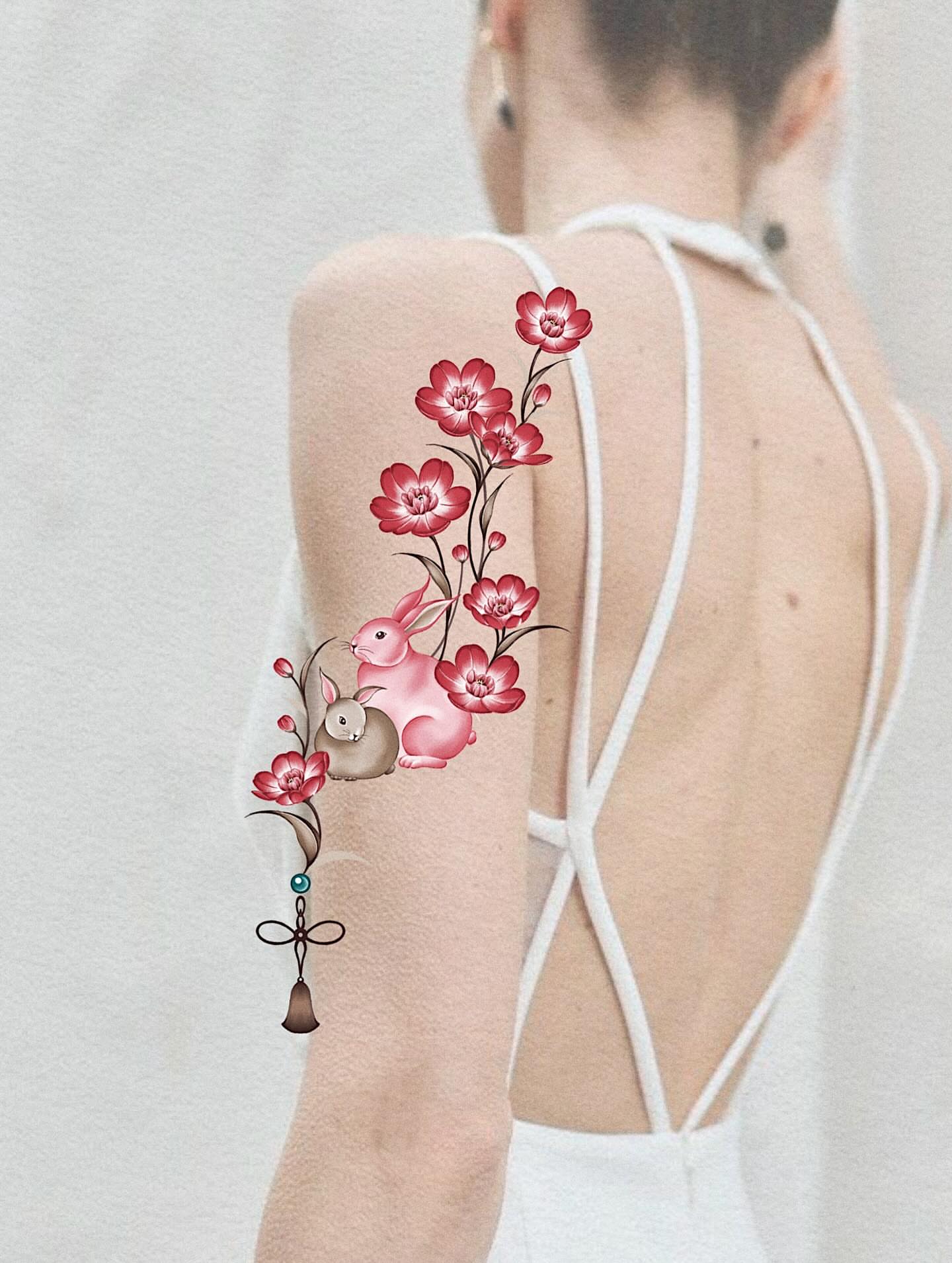 Bunny and flowers illustrative tattoo on the upper arm by 애박 ⋆⁺₊ ₊⁺⋆ Aebak