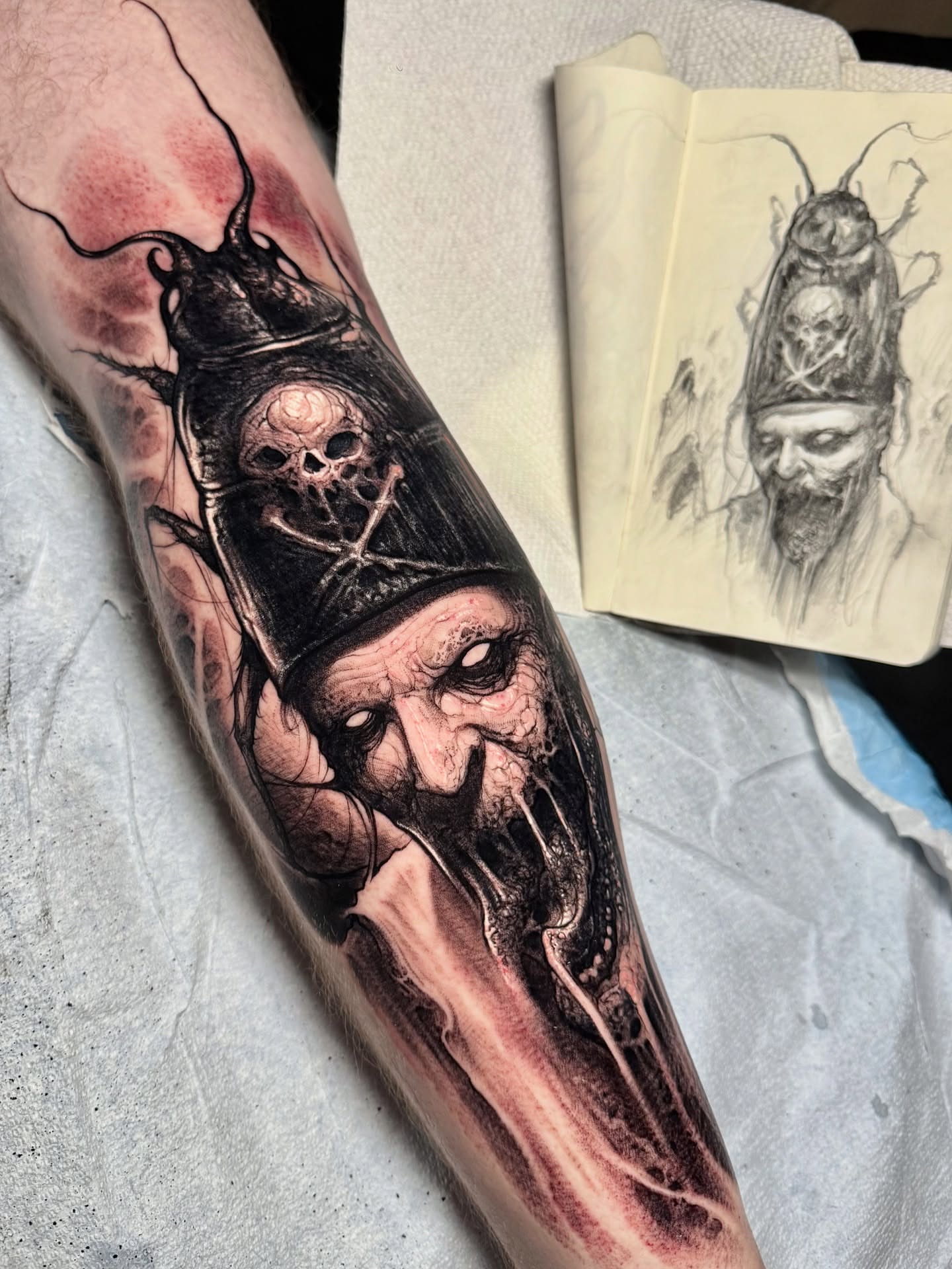 Bearded man with skull dark realism tattoo on the forearm by Brandon Herrera