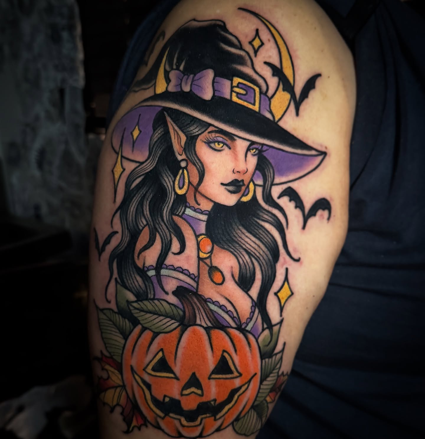Witch and pumpkin American traditional tattoo on the upper arm by K y l e   M a c K e n z i e, Salem, Massachusetts