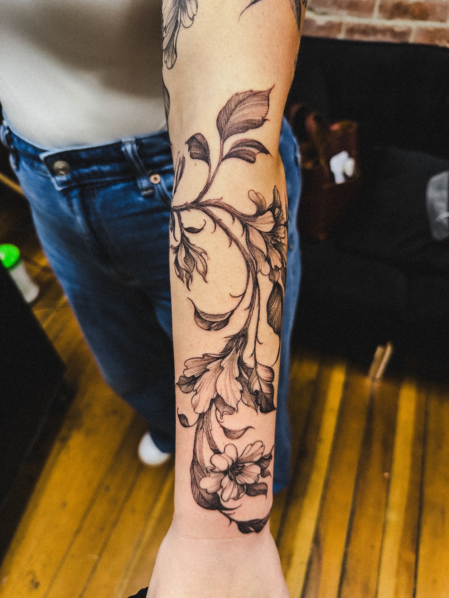 Floral vine black and grey tattoo on the forearm by Brad Simmons